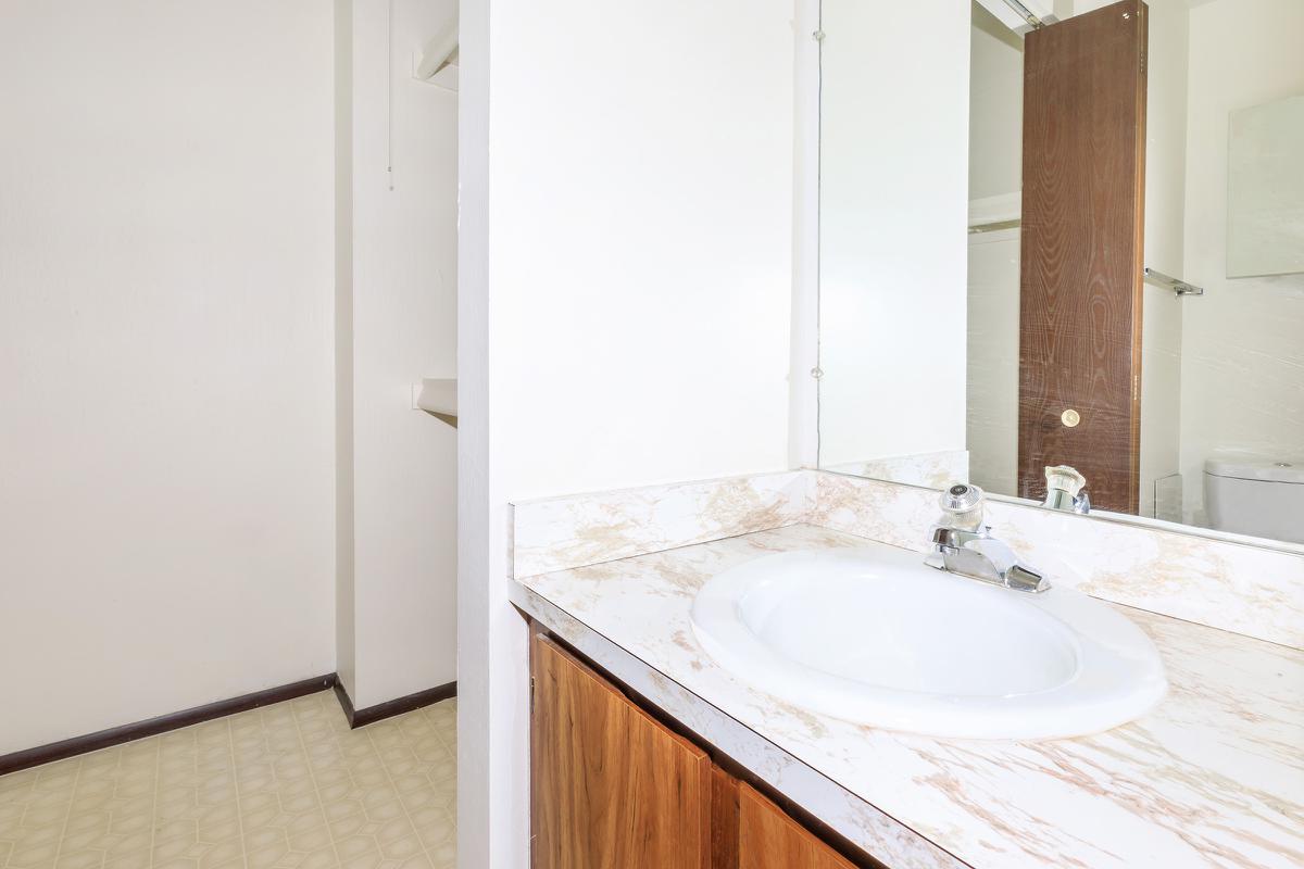 a large white tub next to a sink