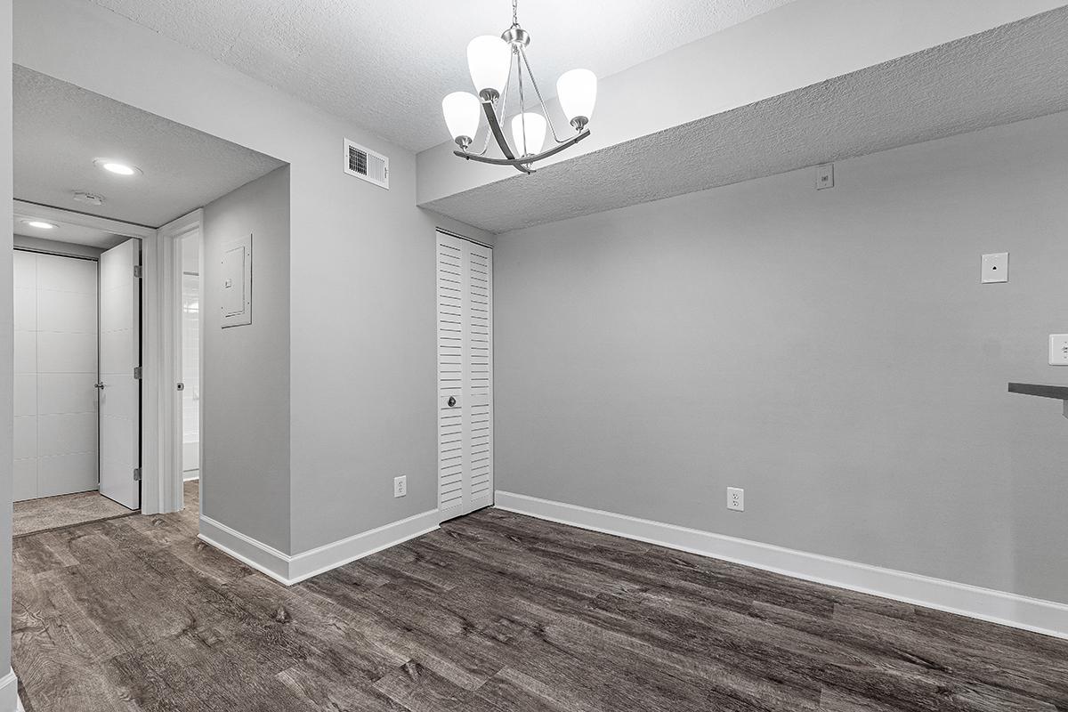 a large empty room with a sink and a mirror