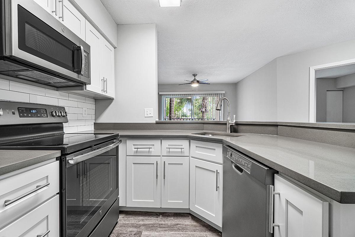 a white stove top oven sitting inside of a kitchen