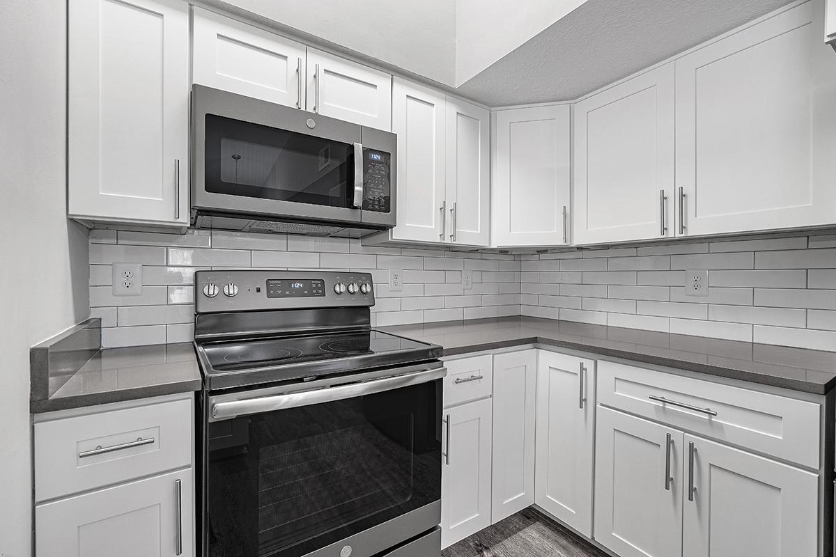 a stove top oven sitting inside of a kitchen