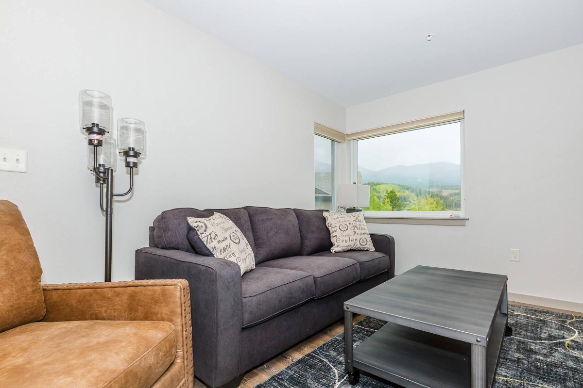 a living room filled with furniture and a flat screen tv