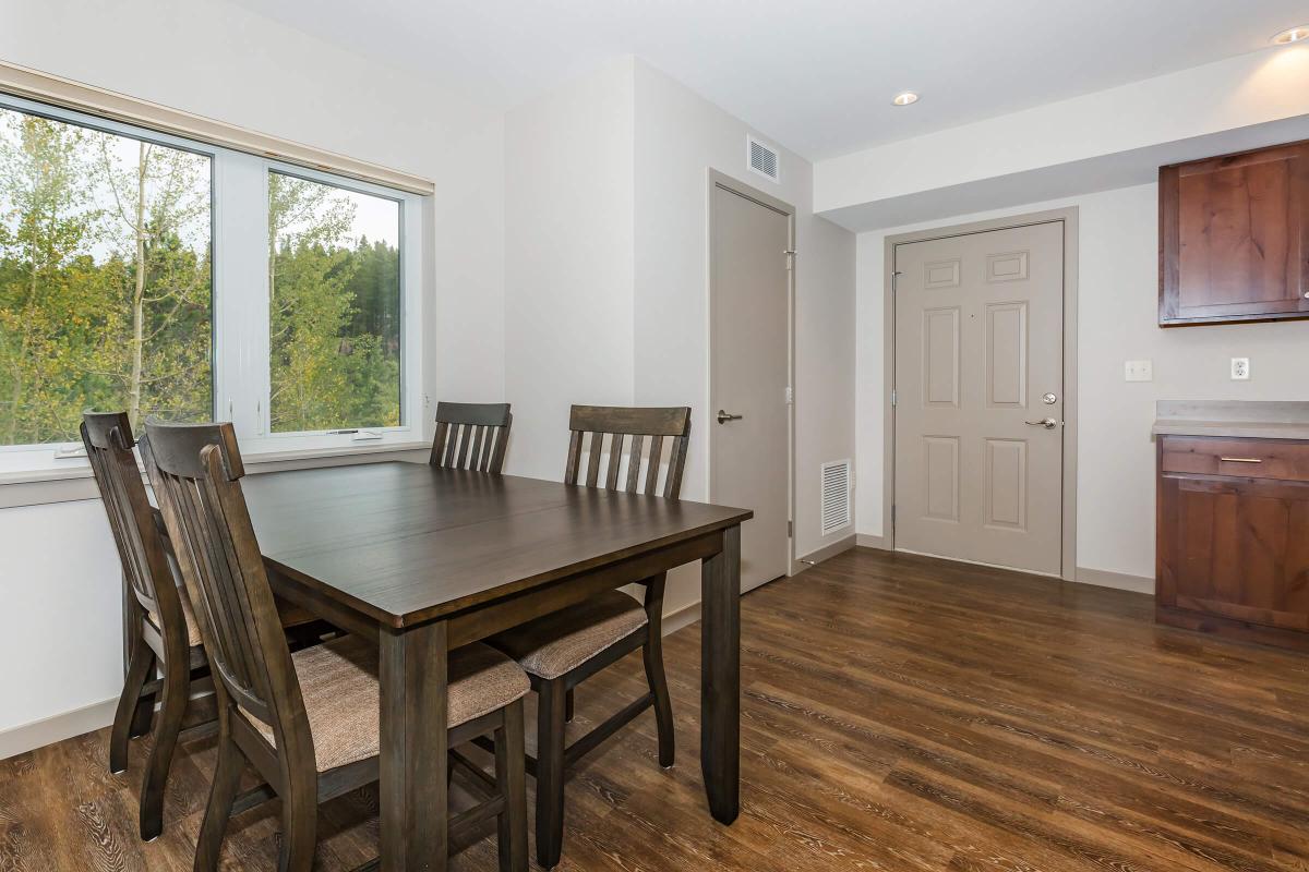 a dining room table in front of a window