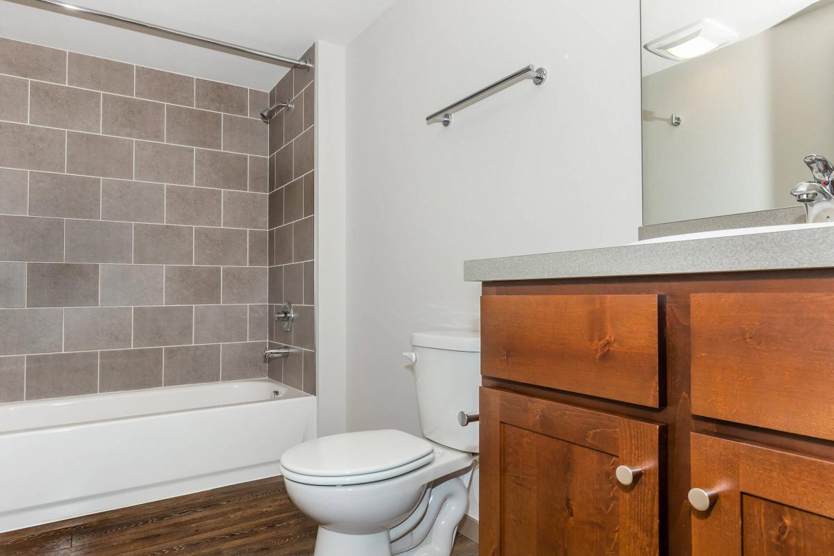 a white sink sitting next to a shower