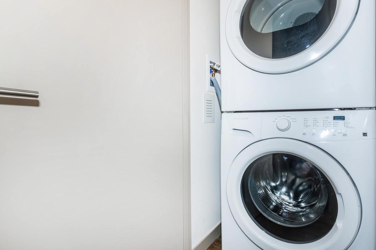 a white refrigerator freezer sitting in a dryer