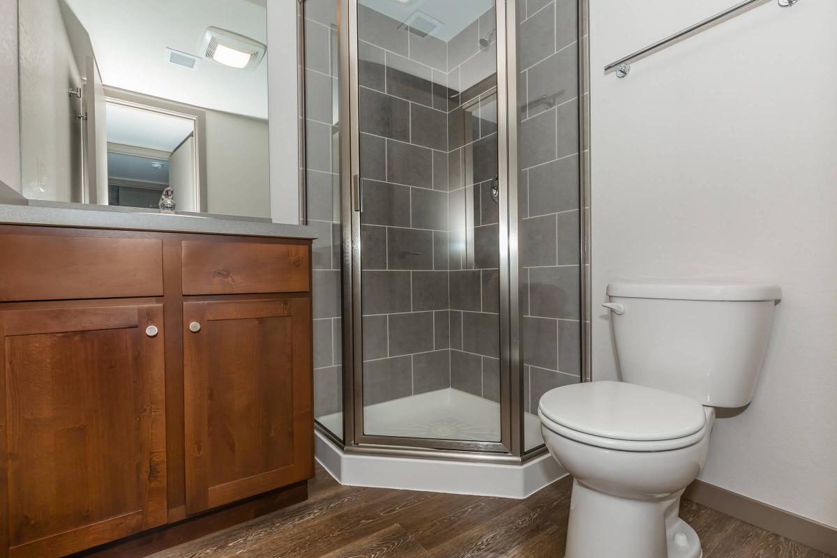 a white sink sitting next to a shower