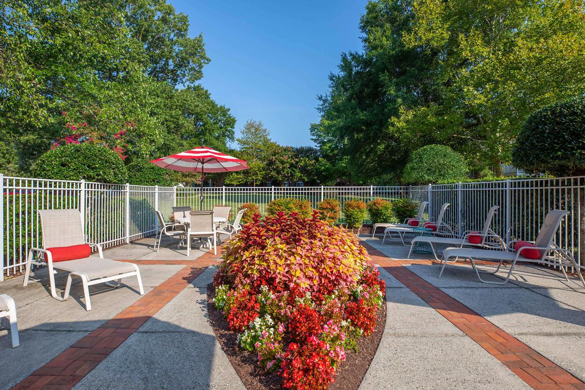 a large red chair in a garden