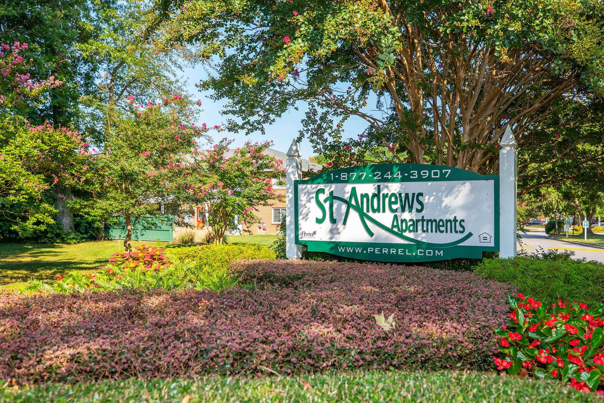 a sign in front of a tree