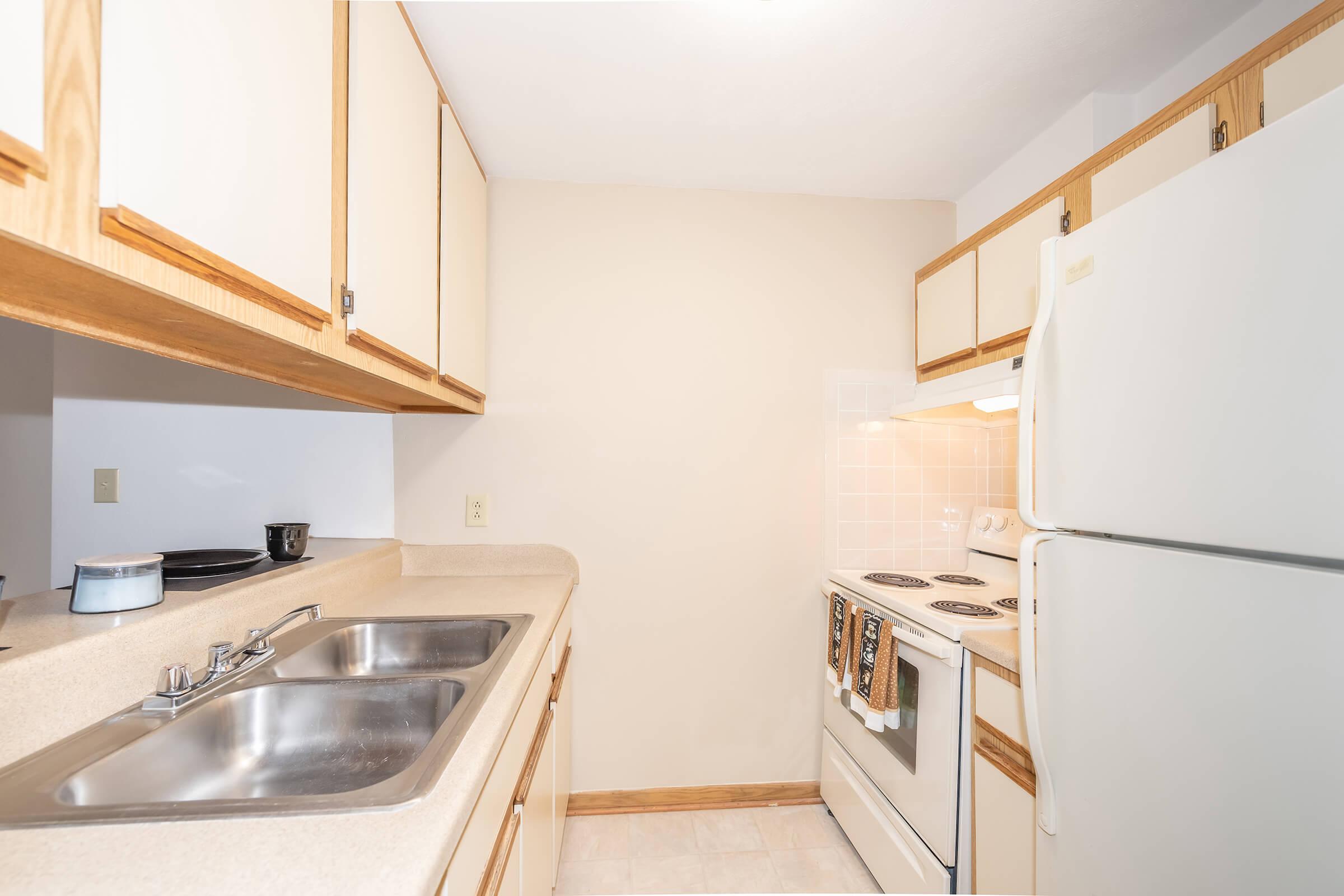 a kitchen with a stove sink and refrigerator