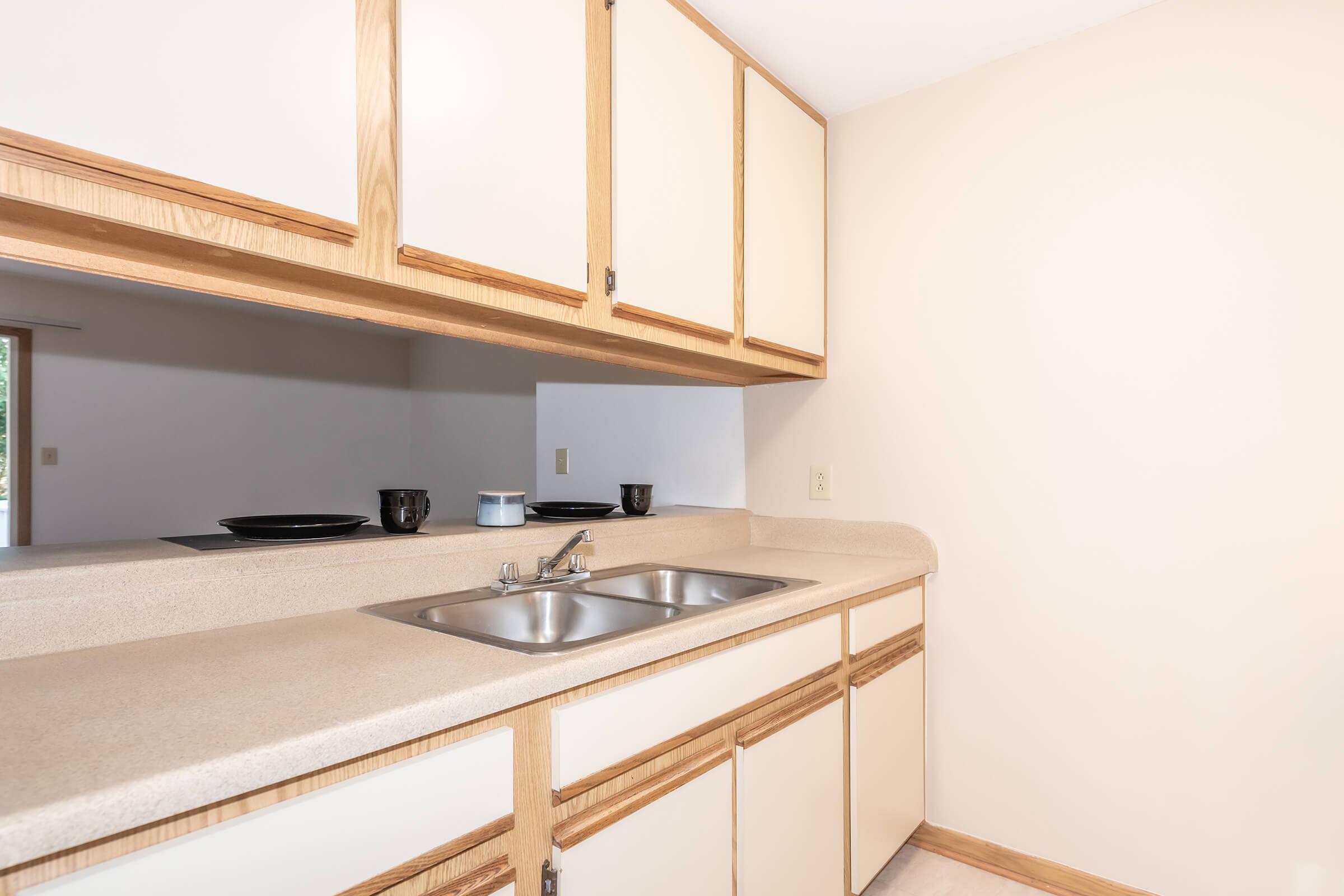 a kitchen with a sink and a mirror