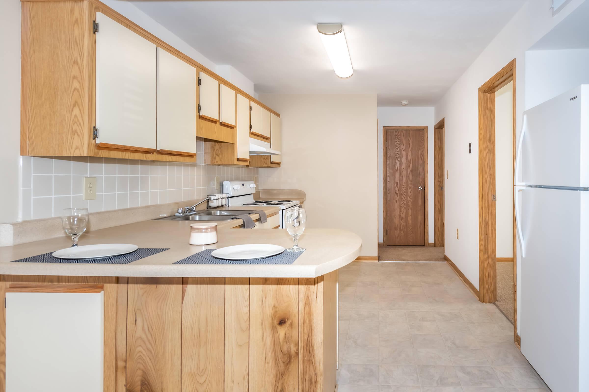 a kitchen with wooden cabinets and a sink