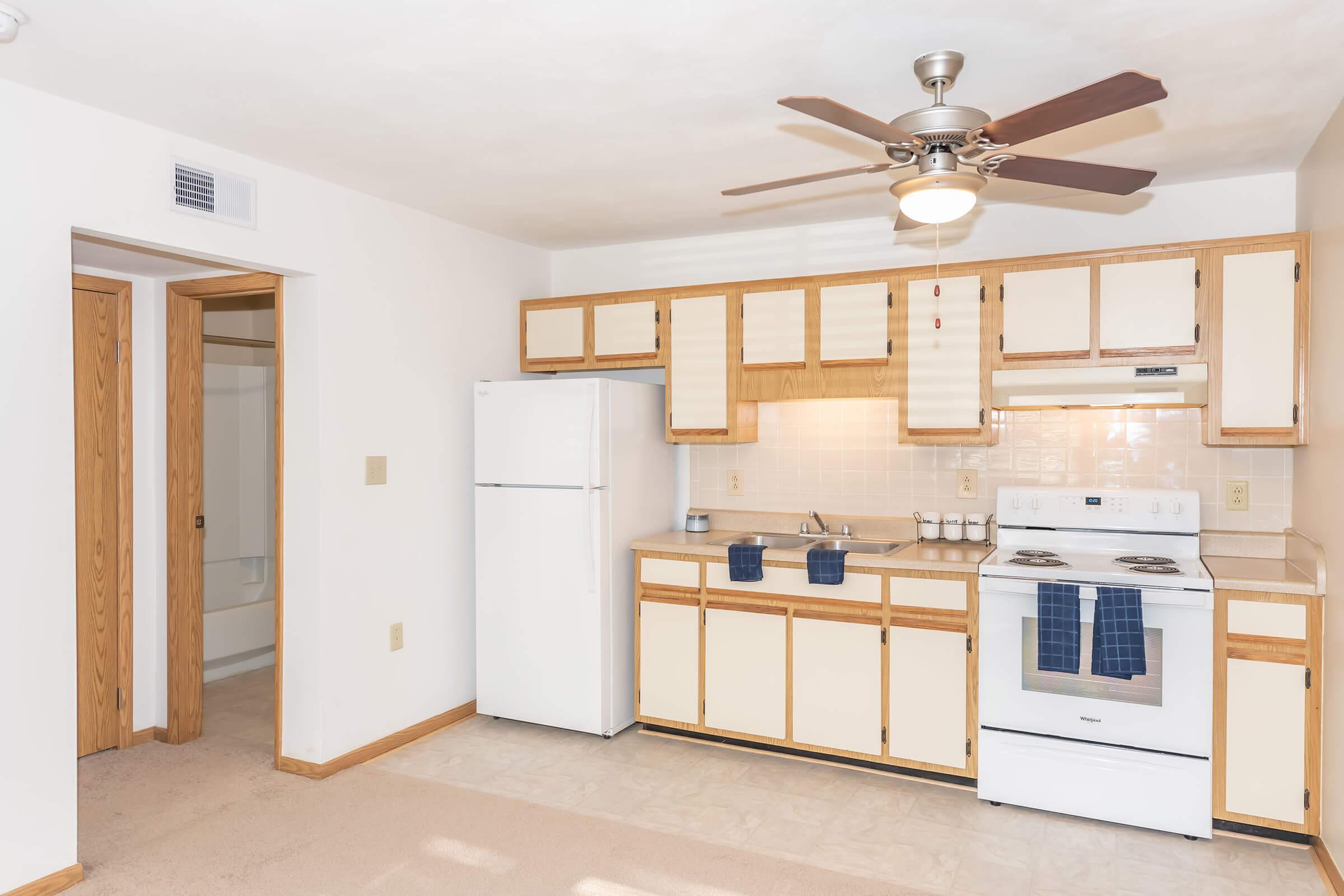 a kitchen with a sink and a mirror in a room