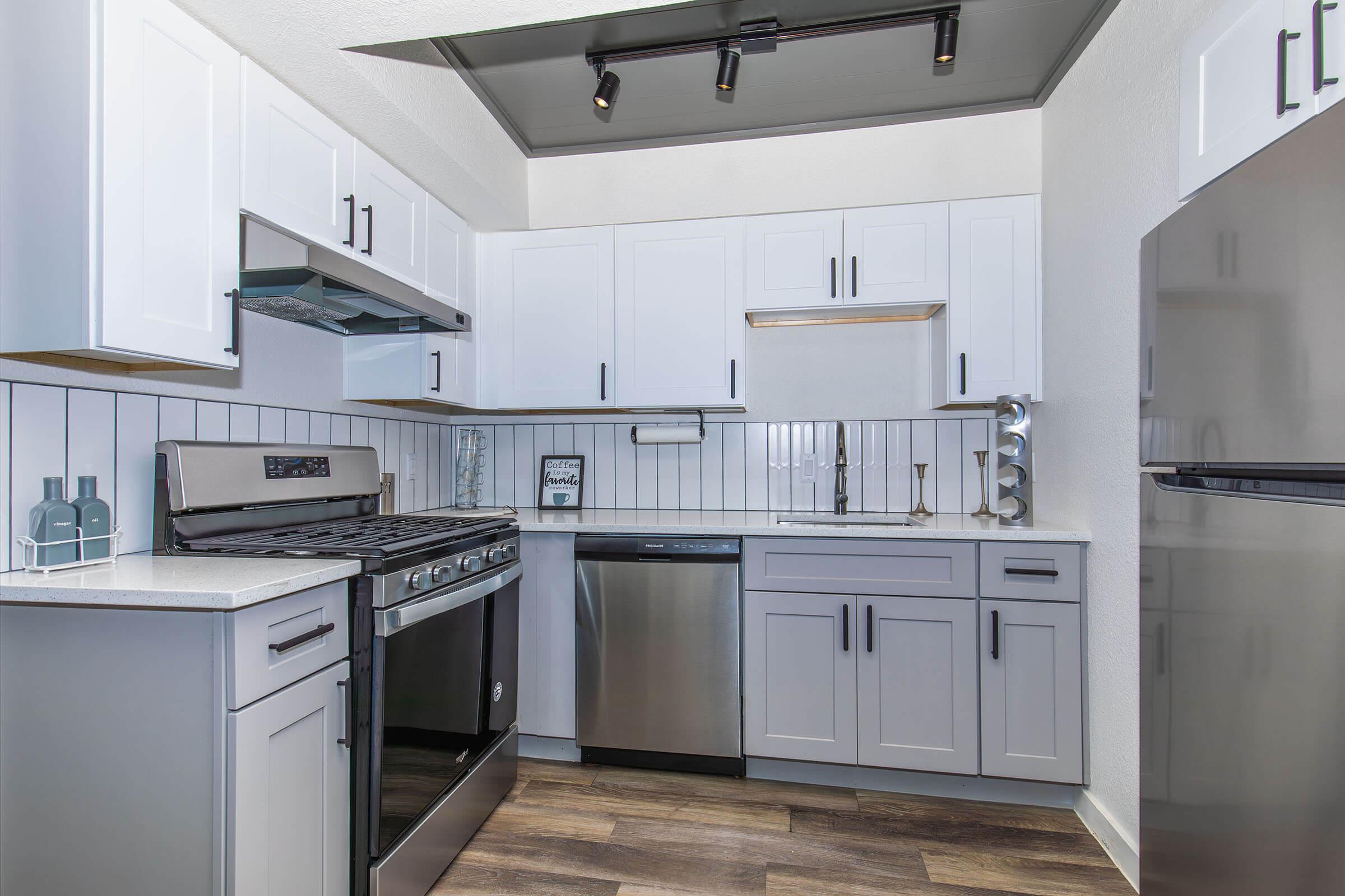 a kitchen with a stove sink and refrigerator