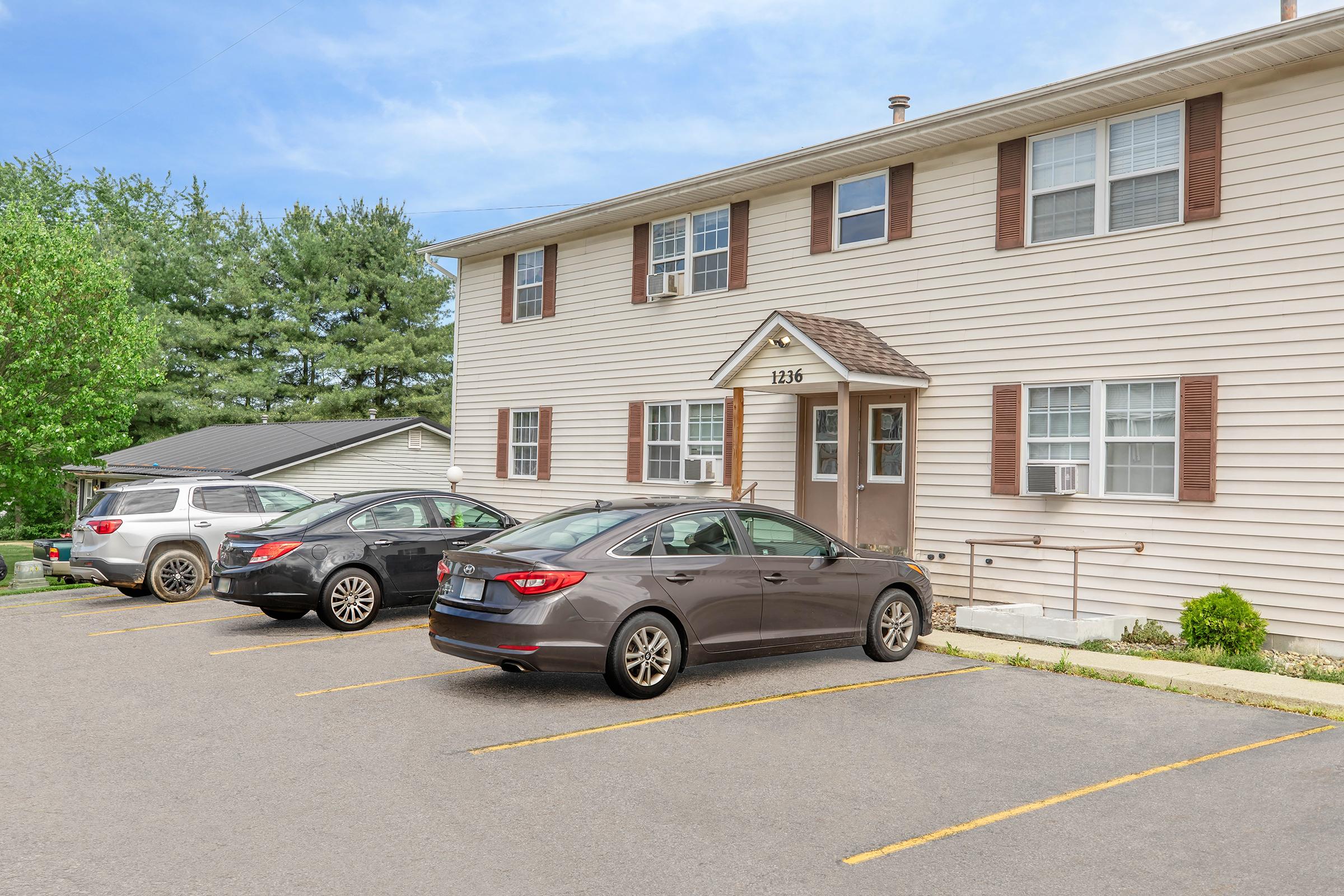 a car parked in a parking lot in front of a house