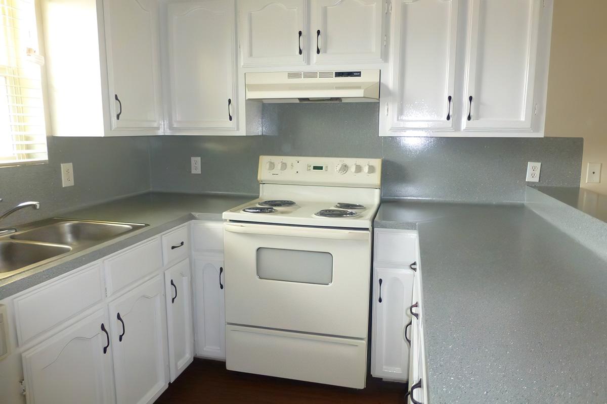 a stove top oven sitting inside of a kitchen