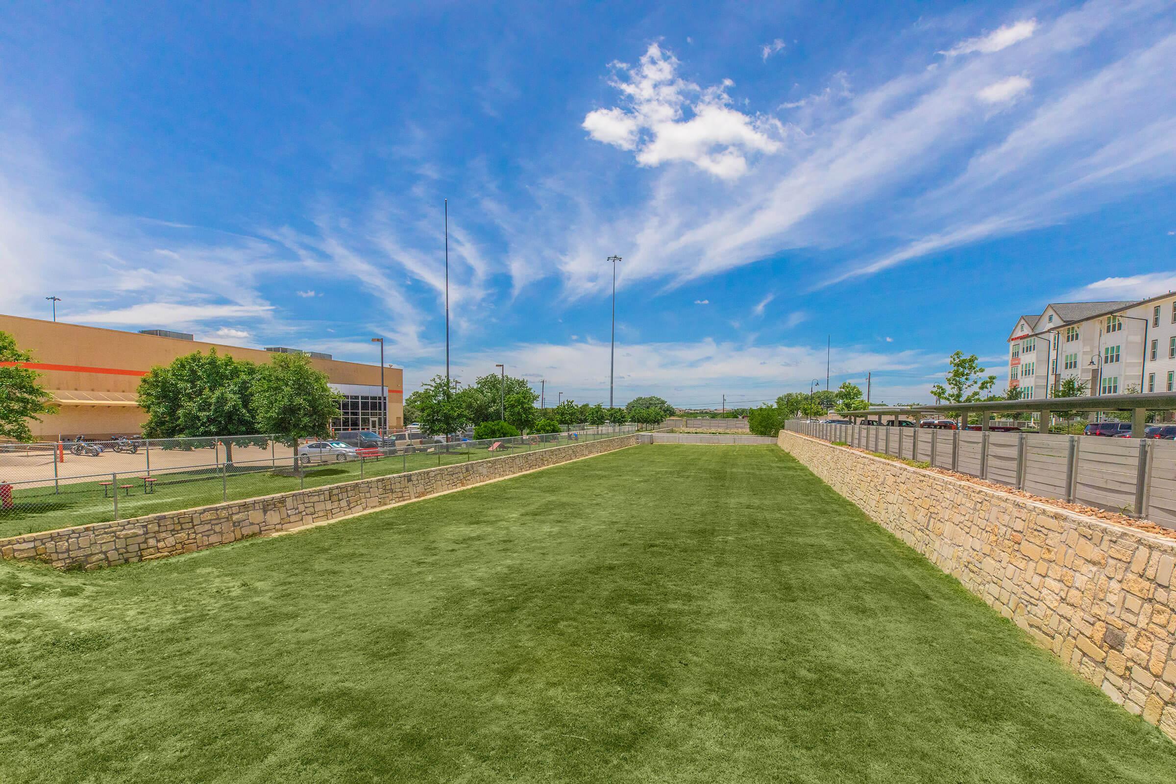 a large green field with stone walls