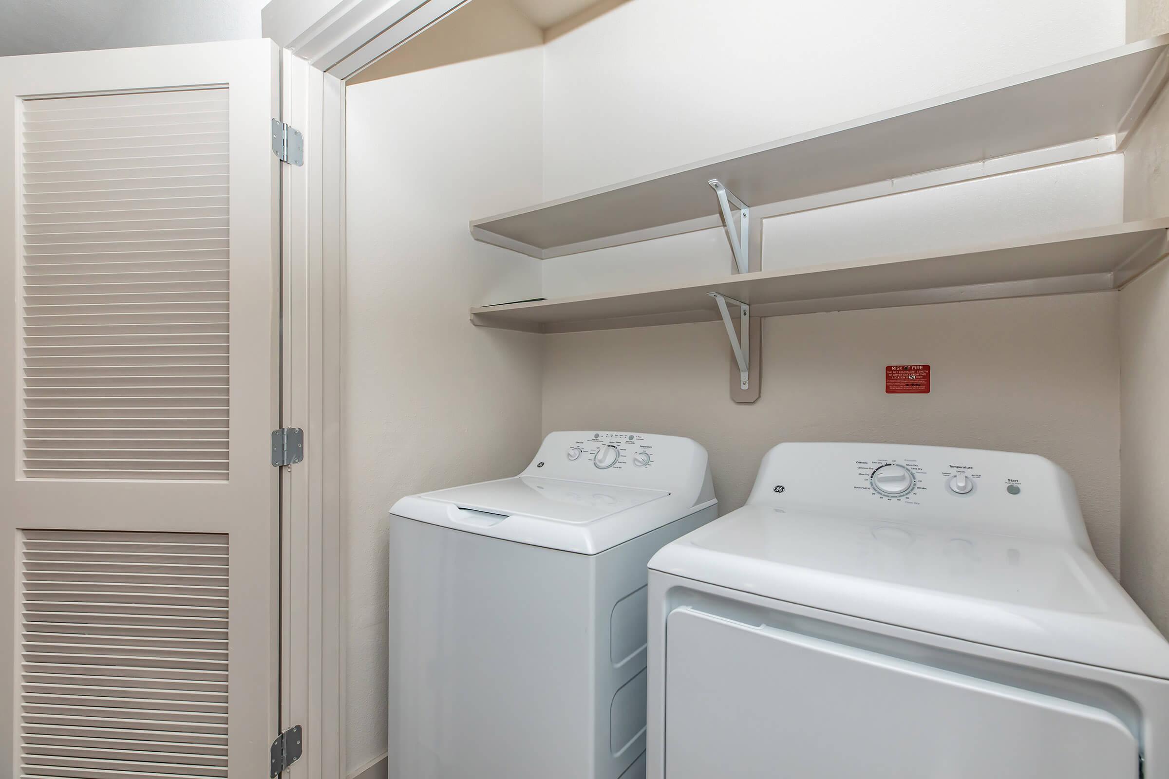 a white refrigerator freezer sitting inside of a building