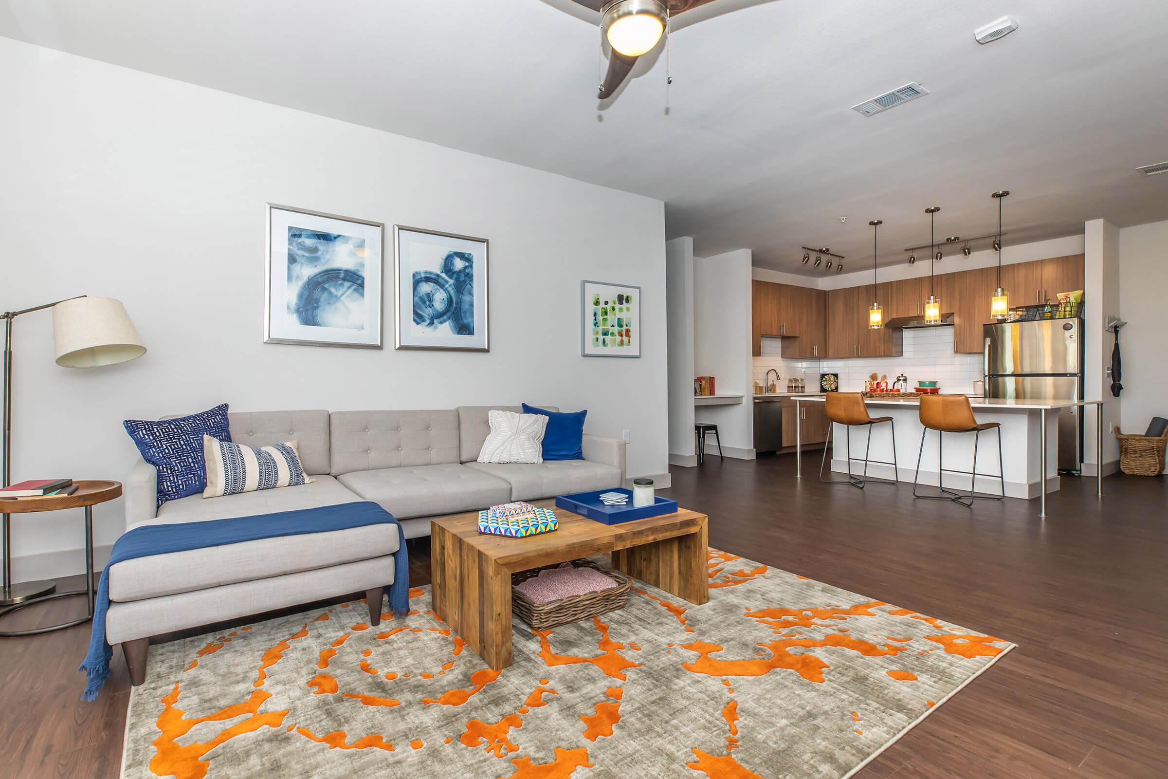 a living room filled with furniture and a wooden table