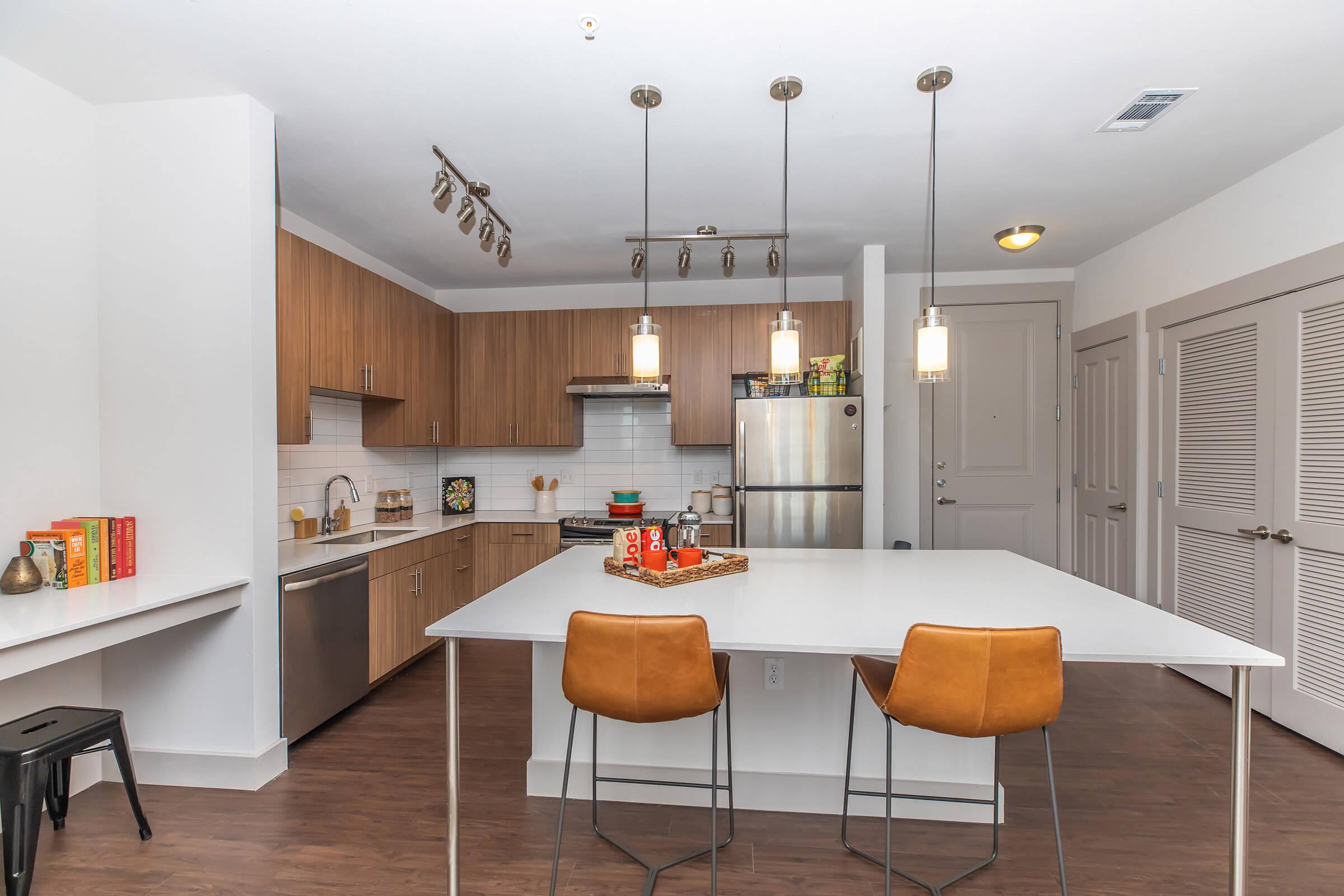 a kitchen with pendent lights