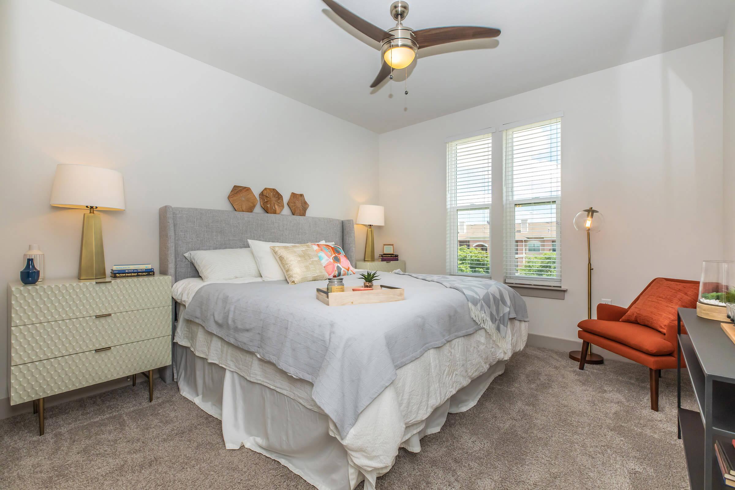 a bedroom with a bed and a red chair