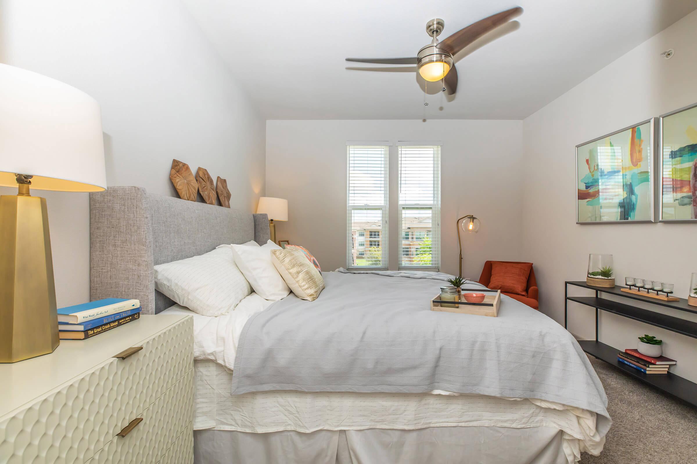 a bedroom with two paintings