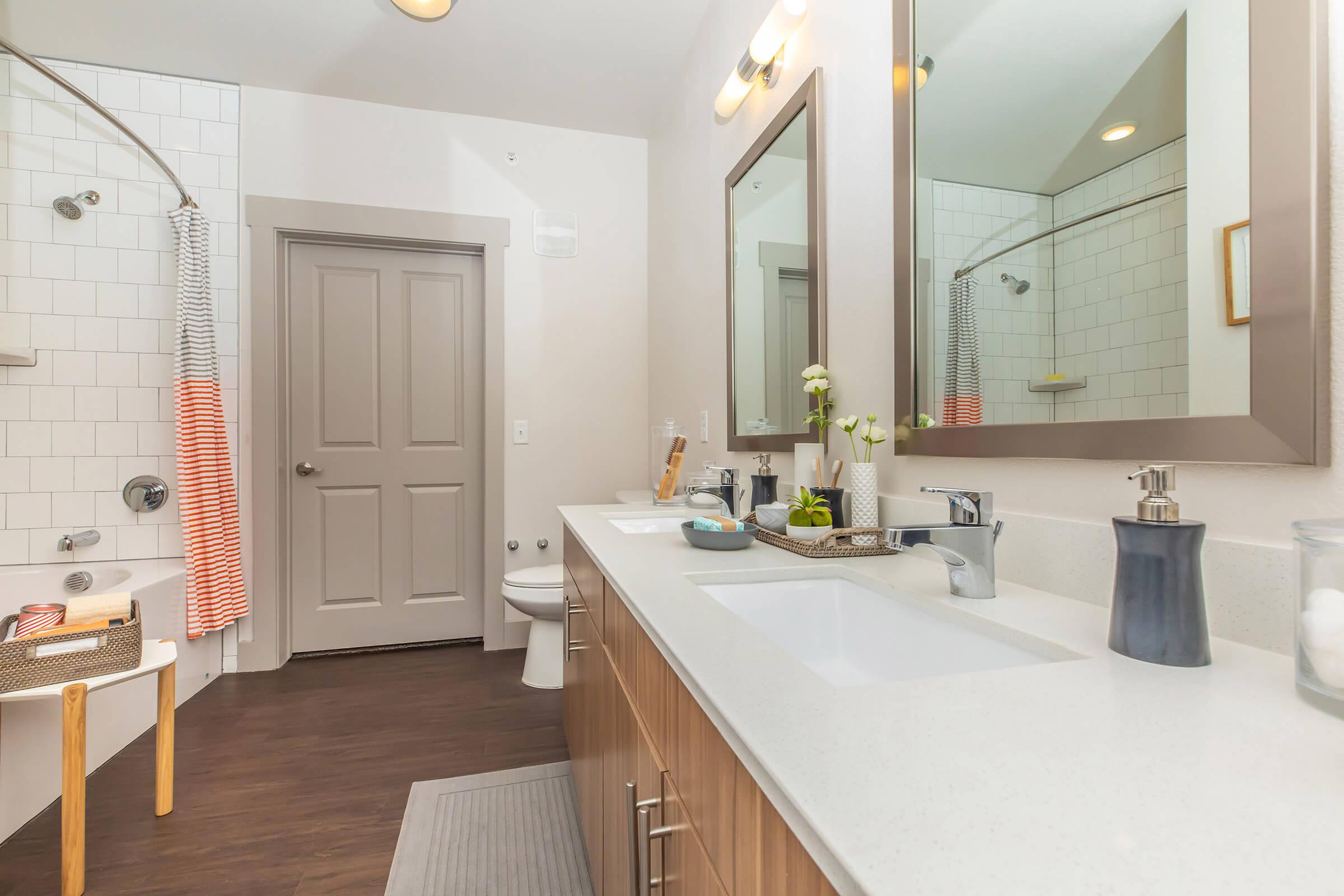 a furnished bathroom with wooden cabinets