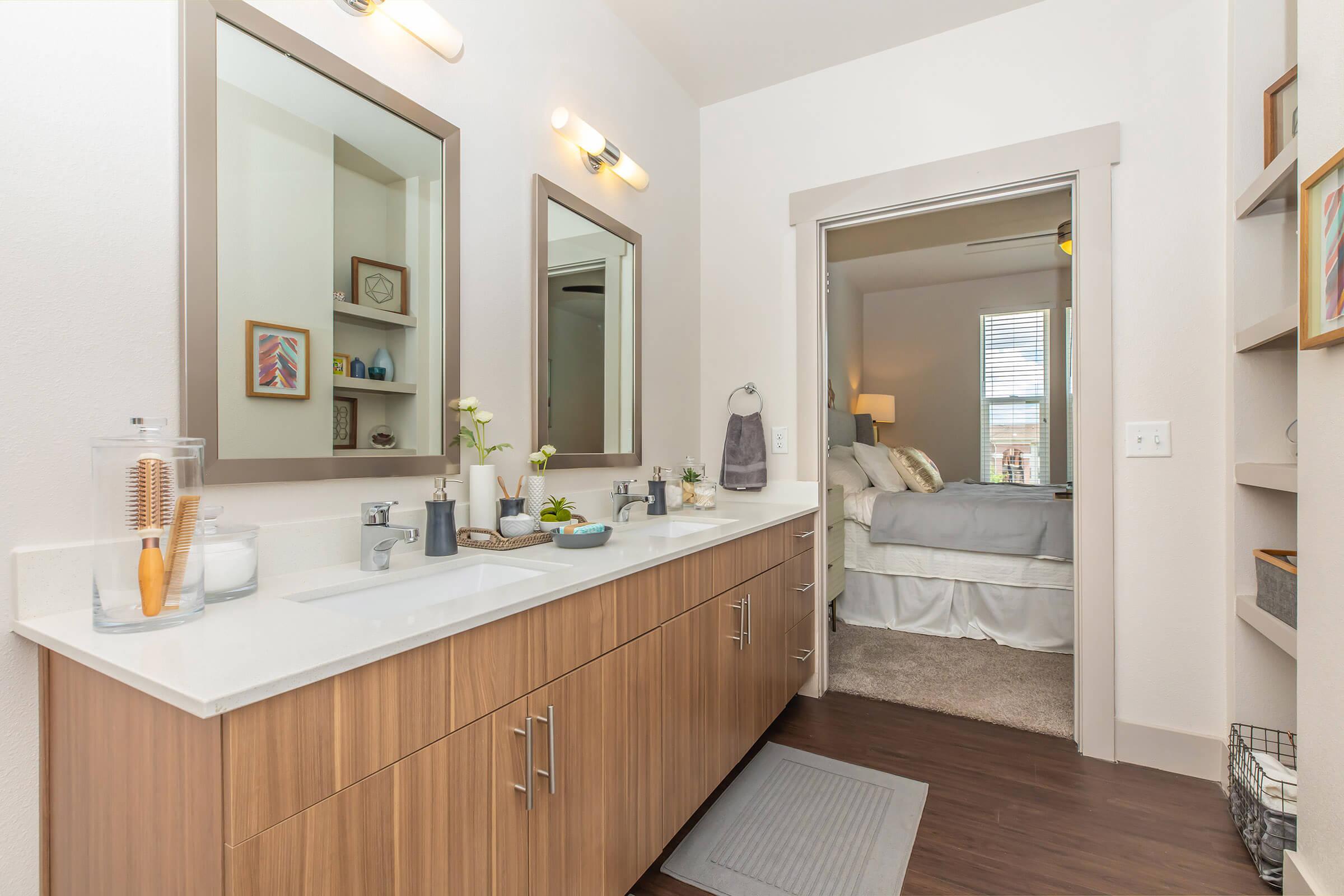 a bathroom with an open door to the bedroom