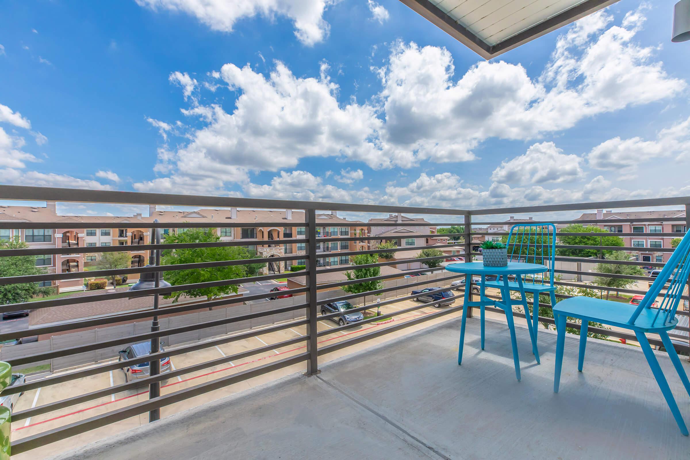 a table and chairs on the balcony