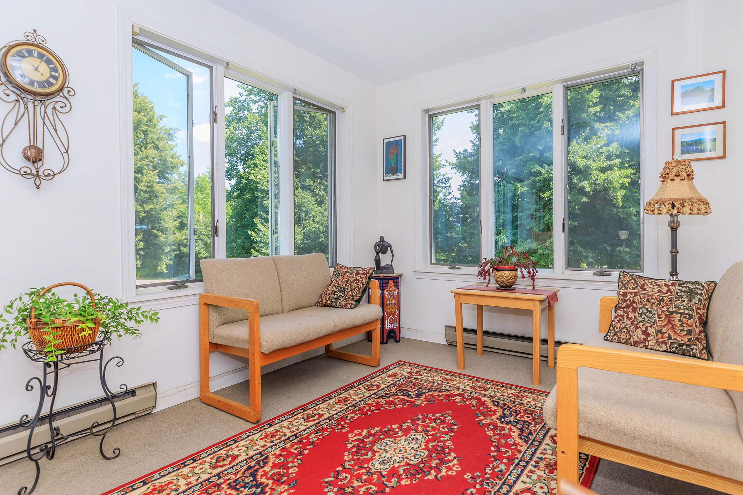 a living room filled with furniture and a large window