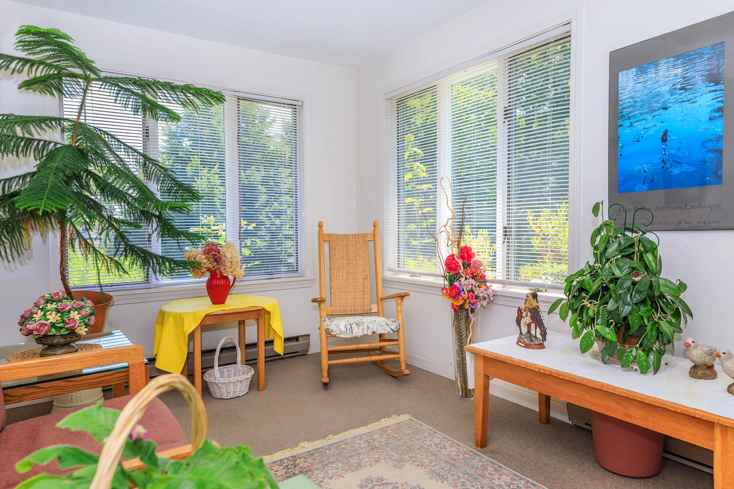 a living room filled with furniture and a large window