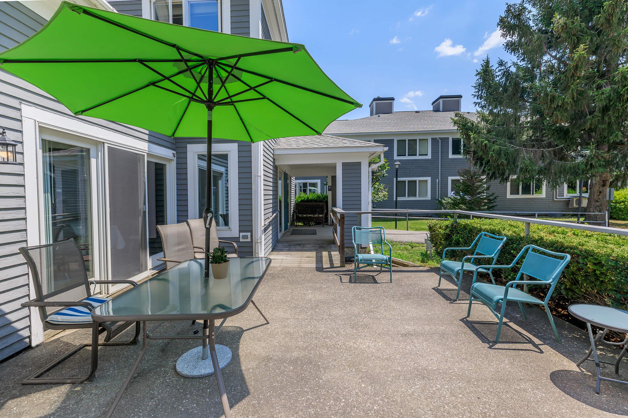 a green lawn chair with an umbrella