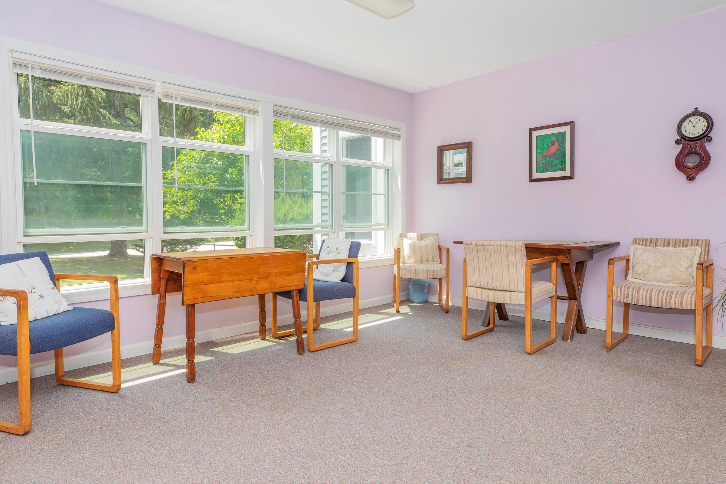 a living room filled with furniture and a large window