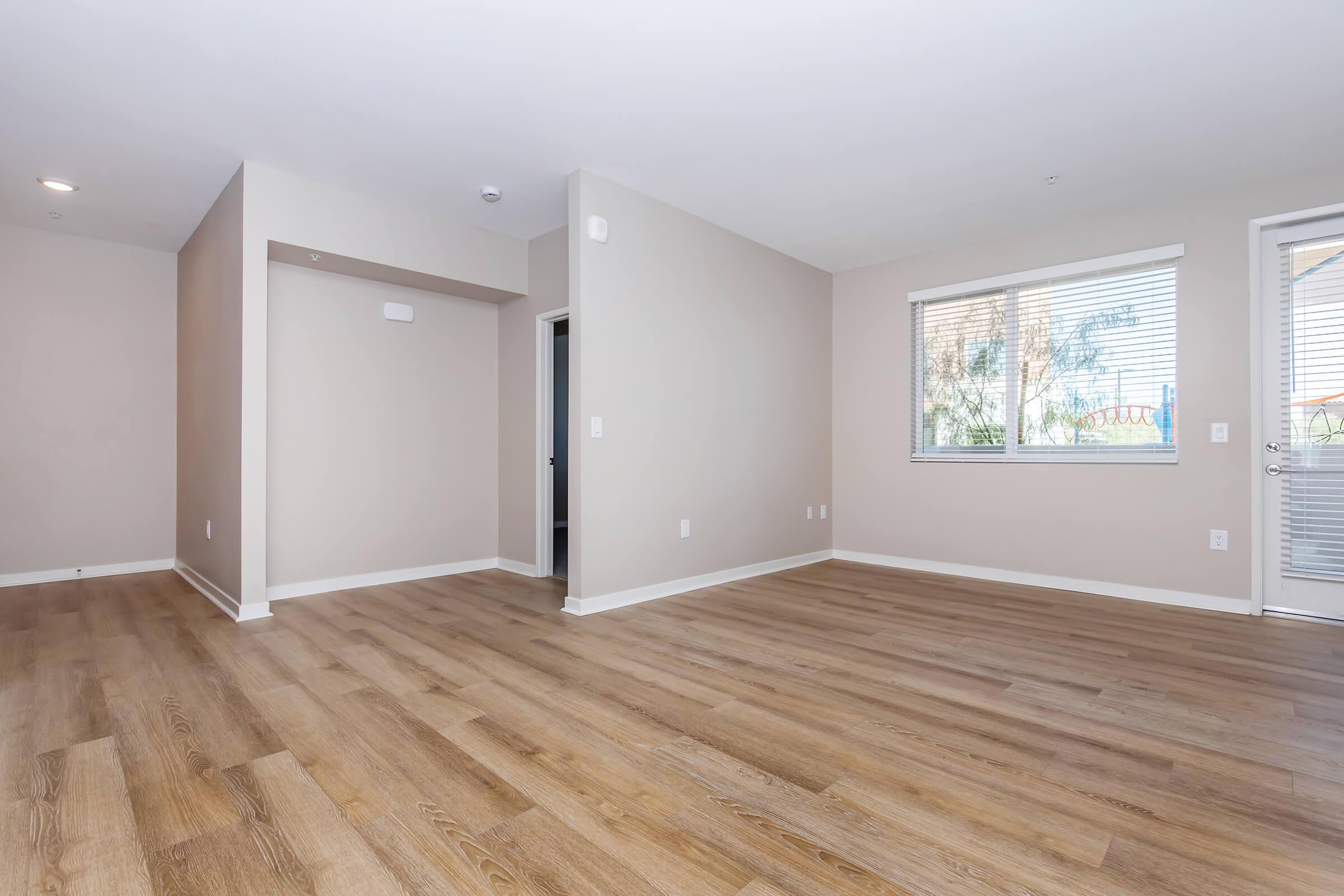 a large empty room with a wood floor