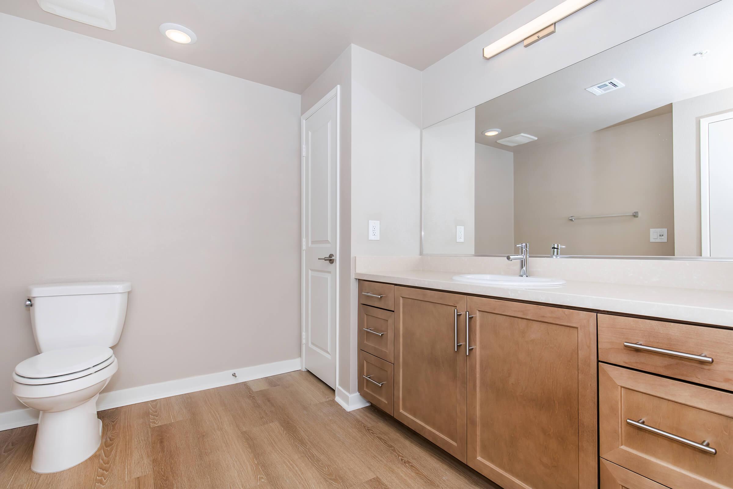 a kitchen with a sink and a mirror