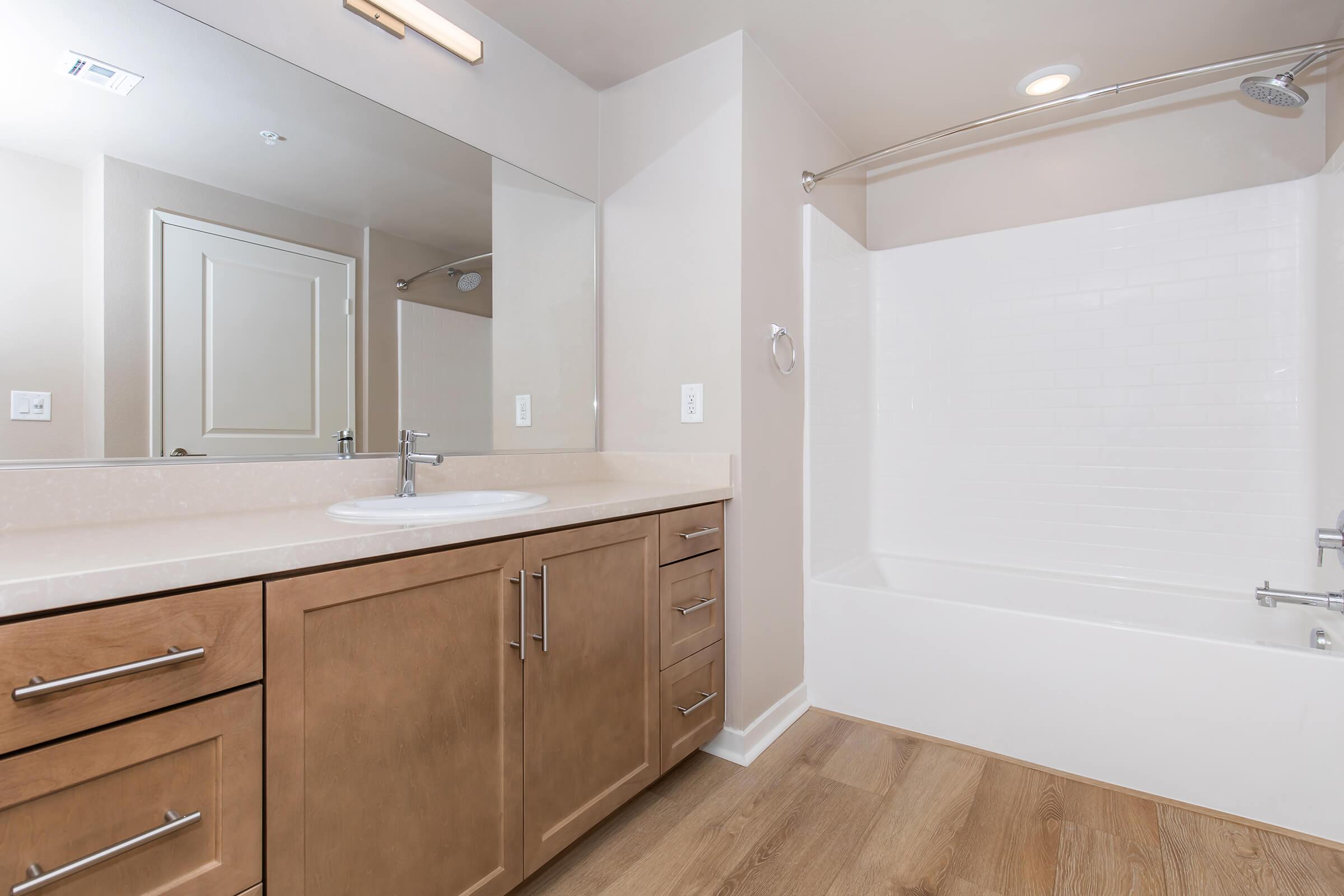 a kitchen with a sink and a mirror