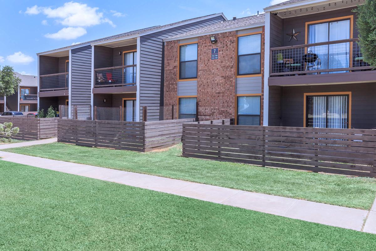 a large lawn in front of a brick building