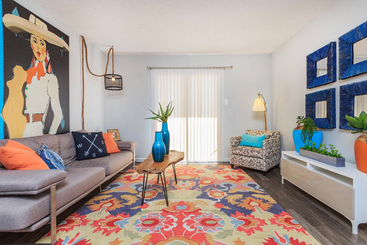 a colorful living room with a bed in a bedroom