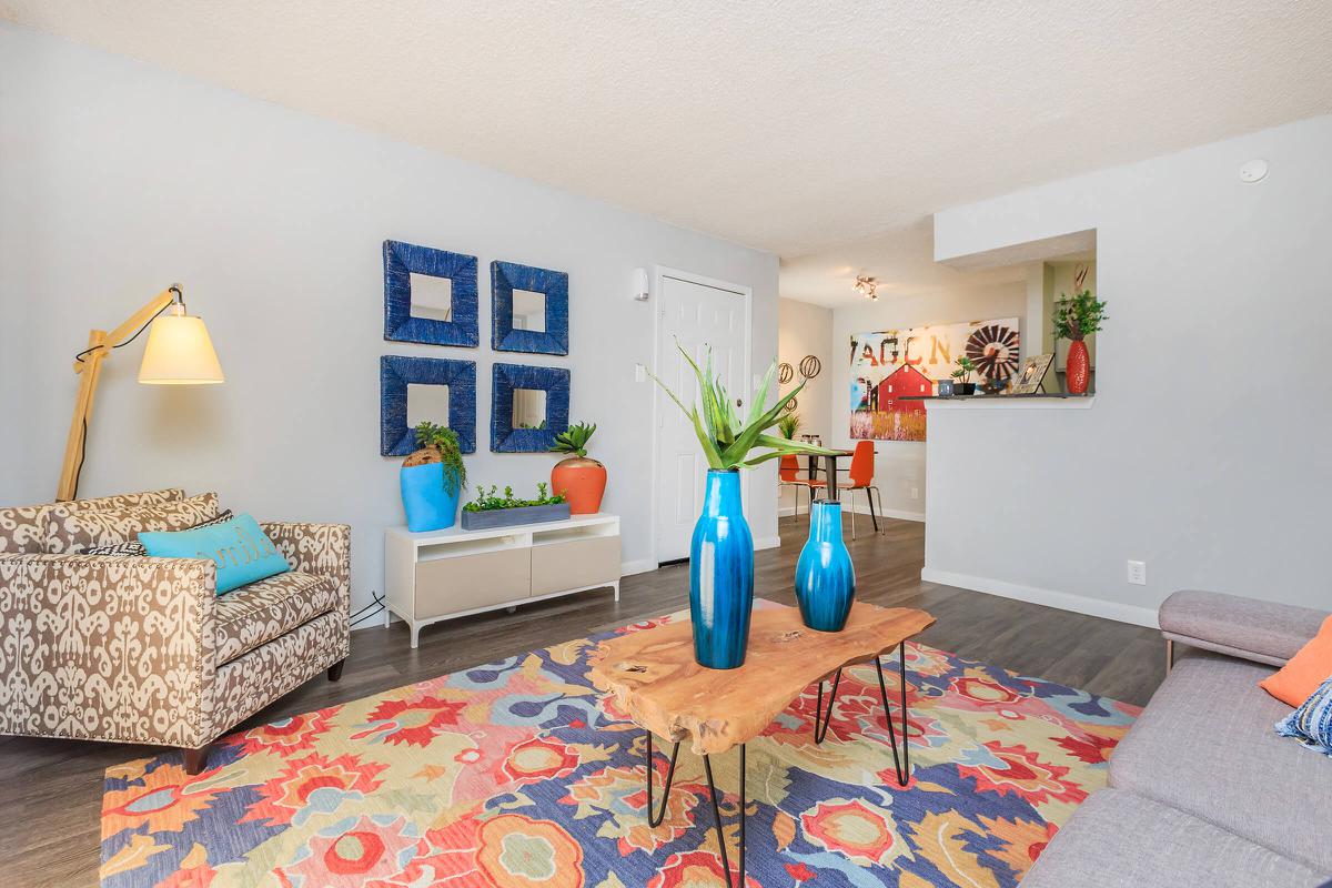 a living room filled with furniture and a rug