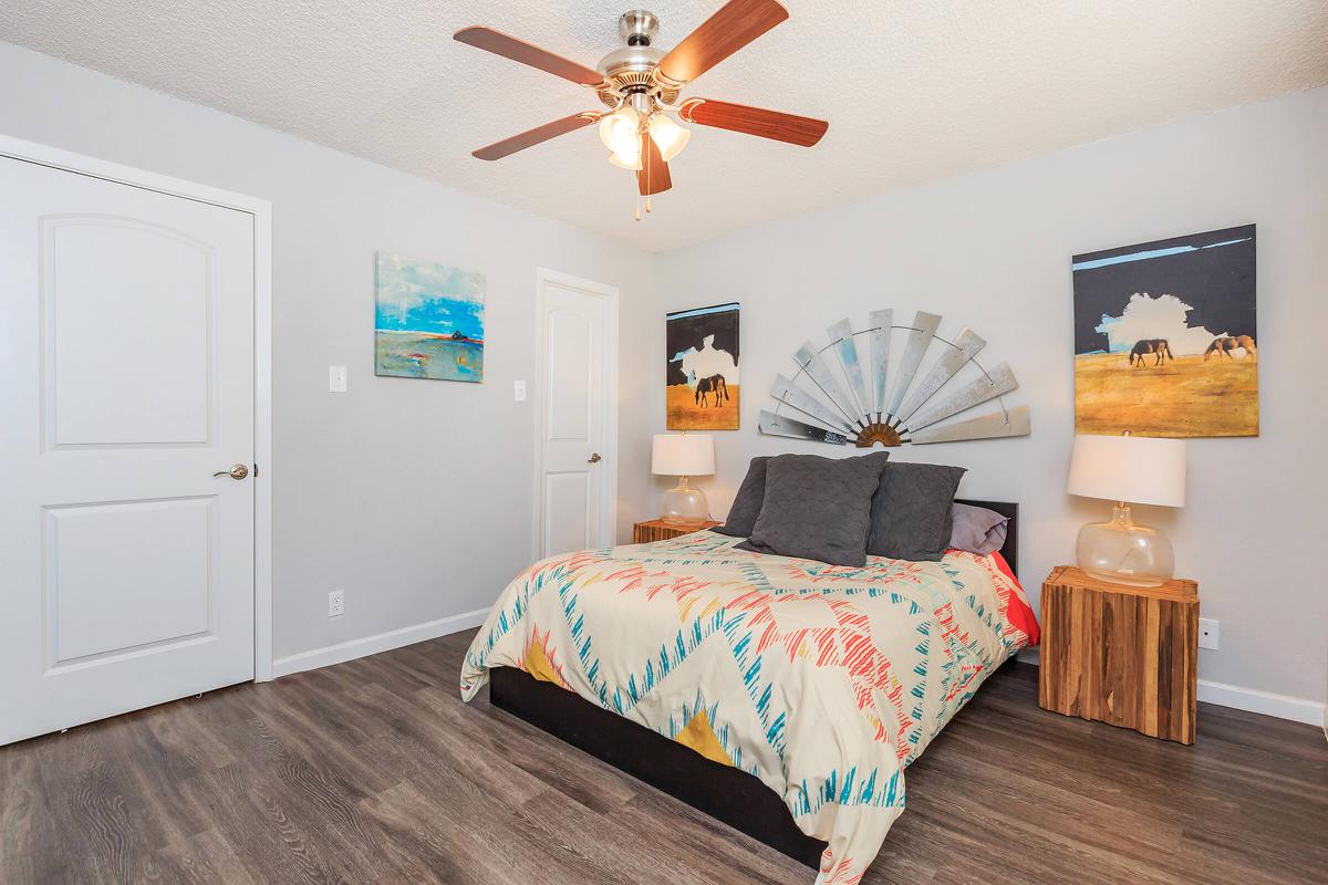 a room with white walls and wooden cabinets