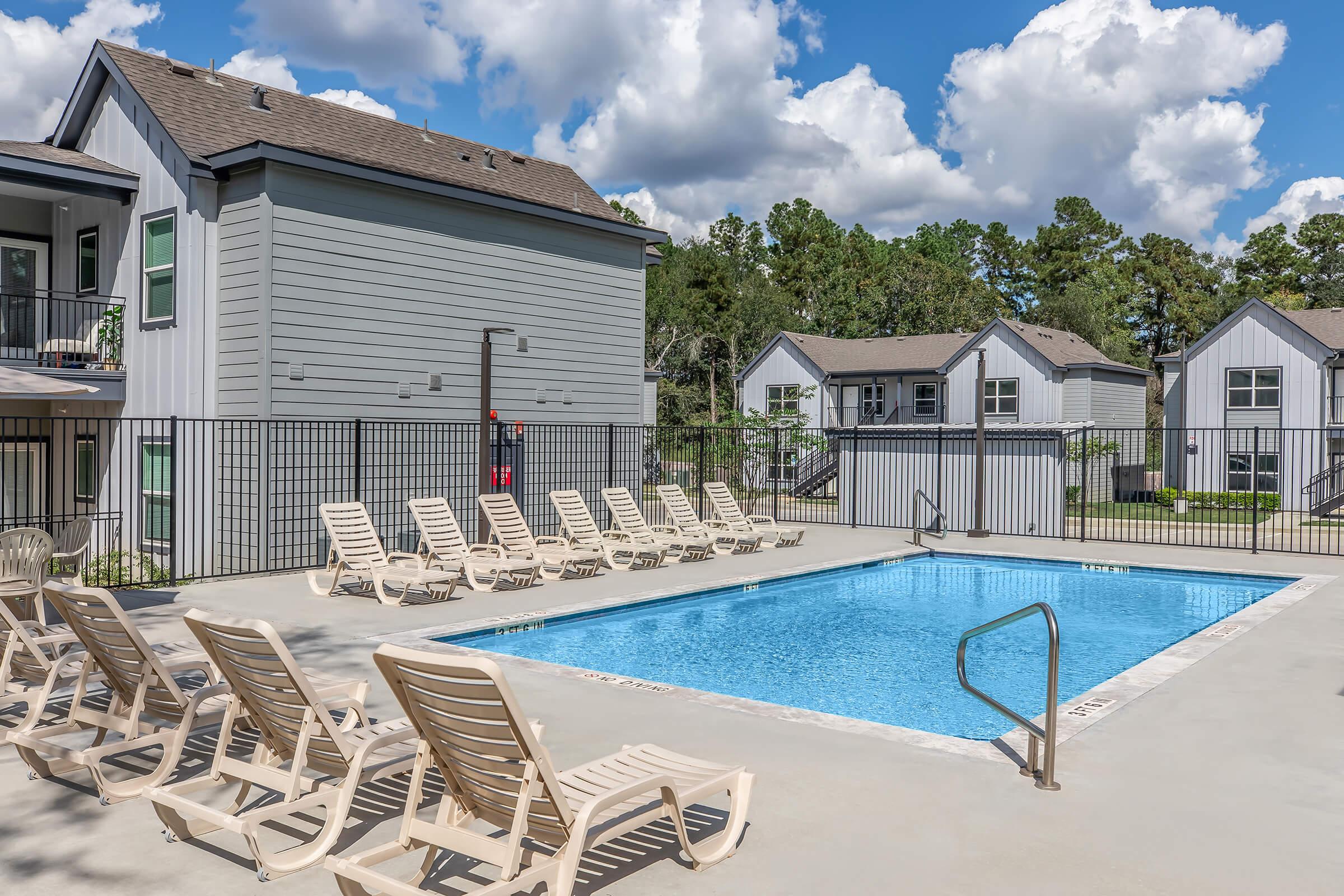 a house with a pool outside of a building