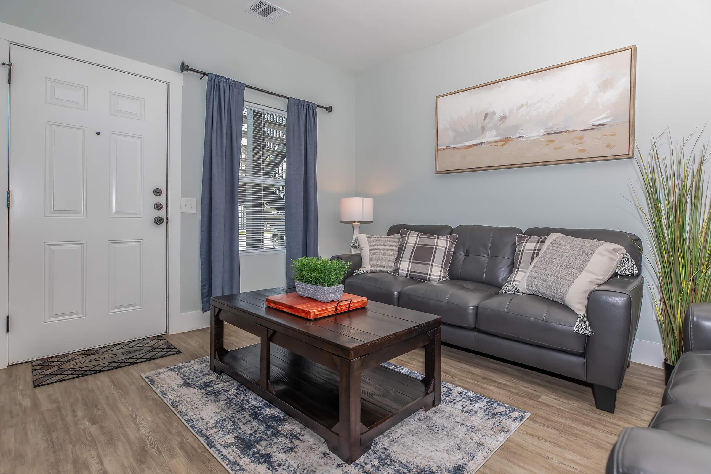 a living room filled with furniture and a large window