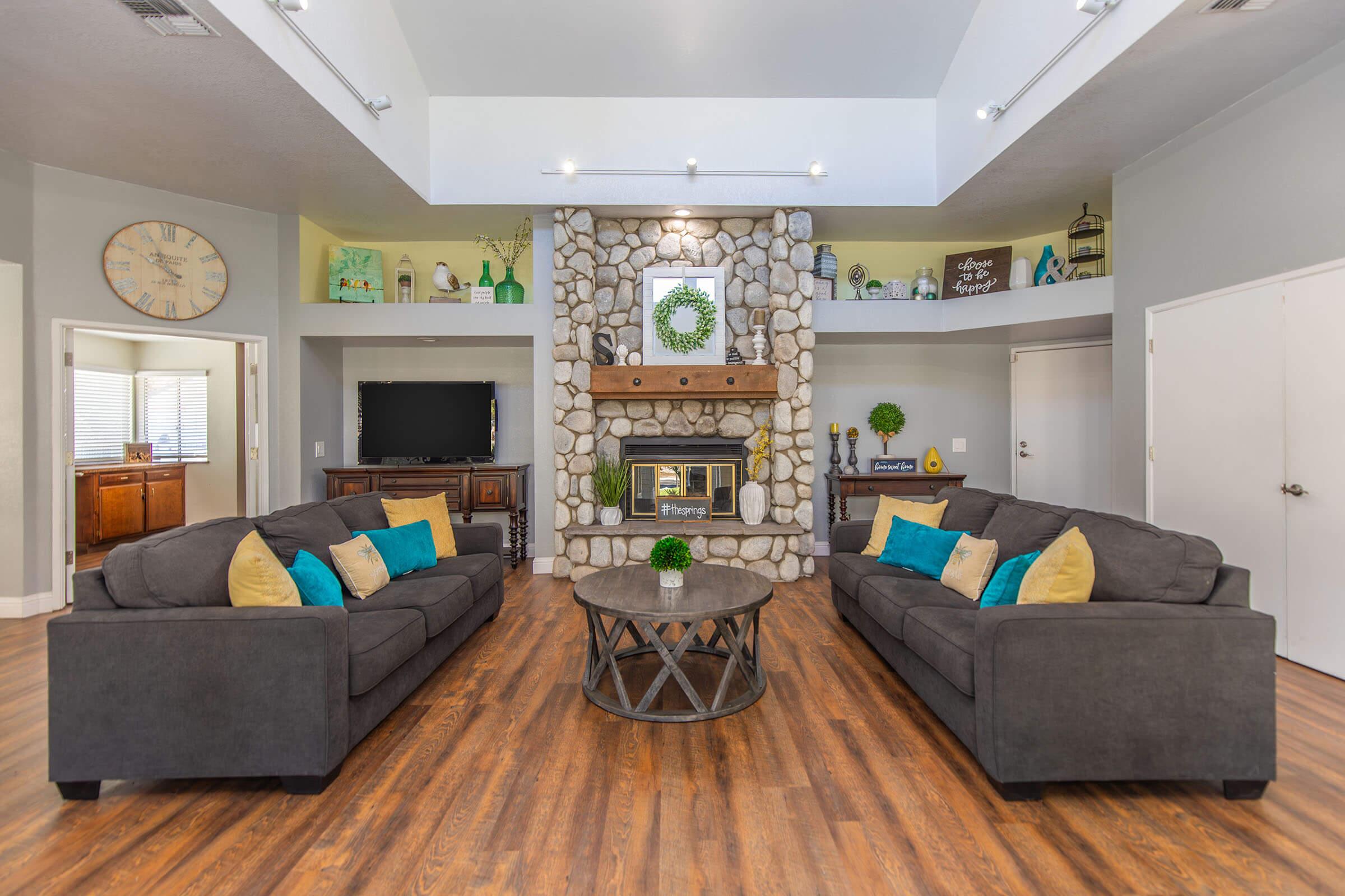 a living room filled with furniture and a fireplace