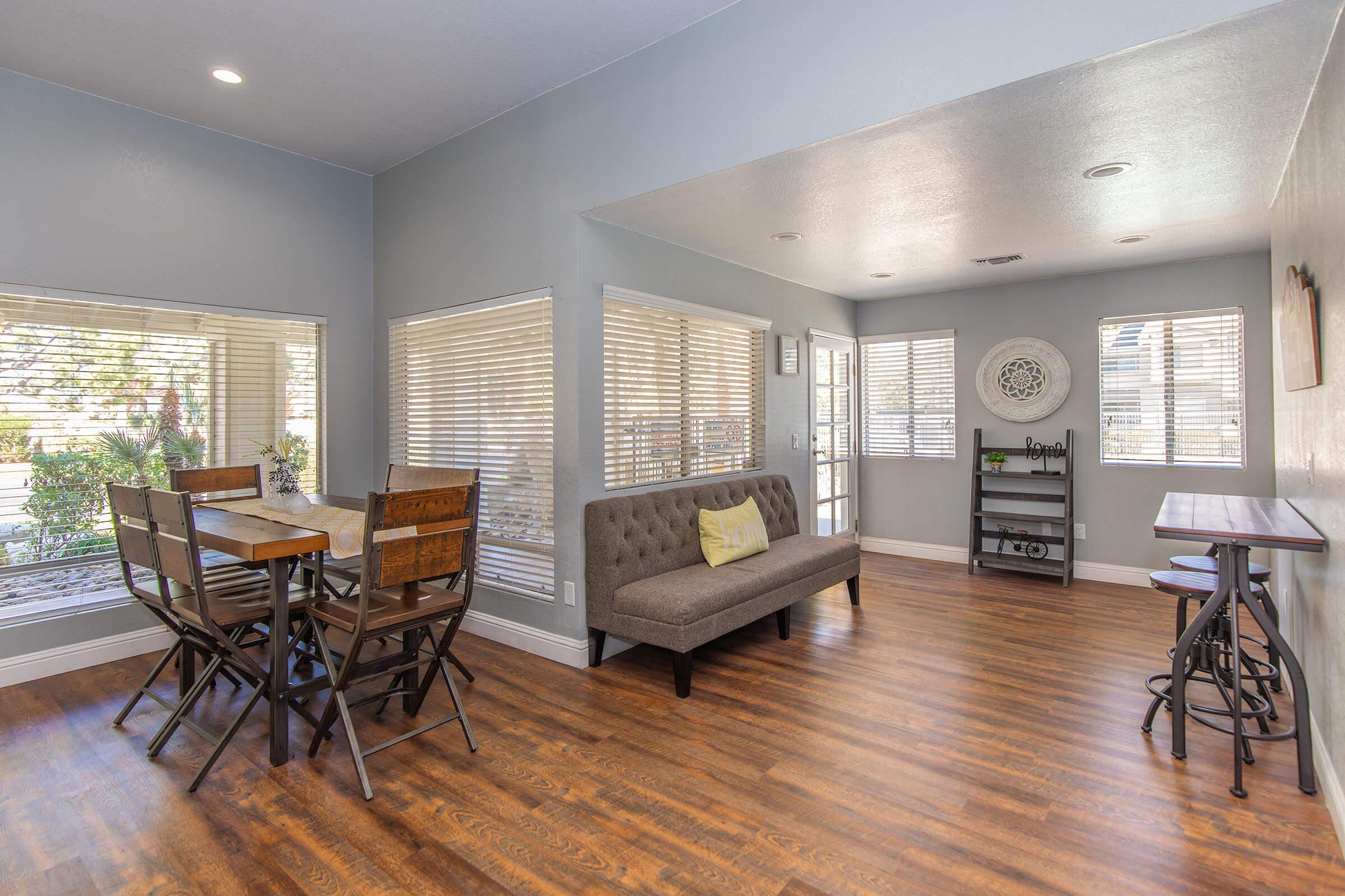 a living room filled with furniture on top of a hard wood floor