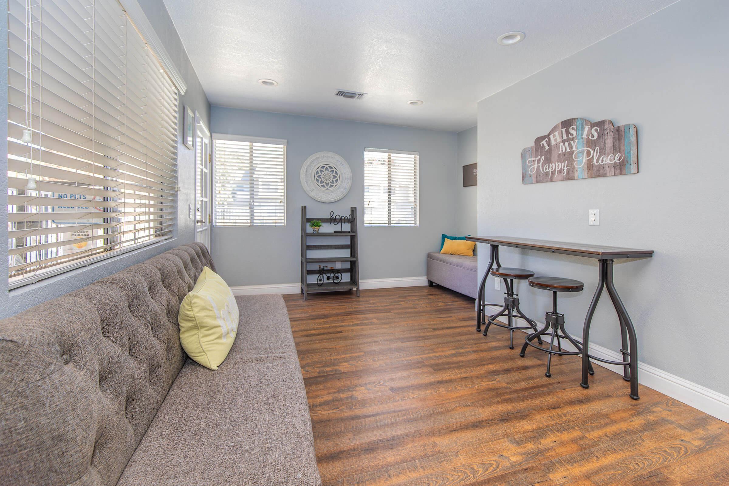 a living room filled with furniture and a large window