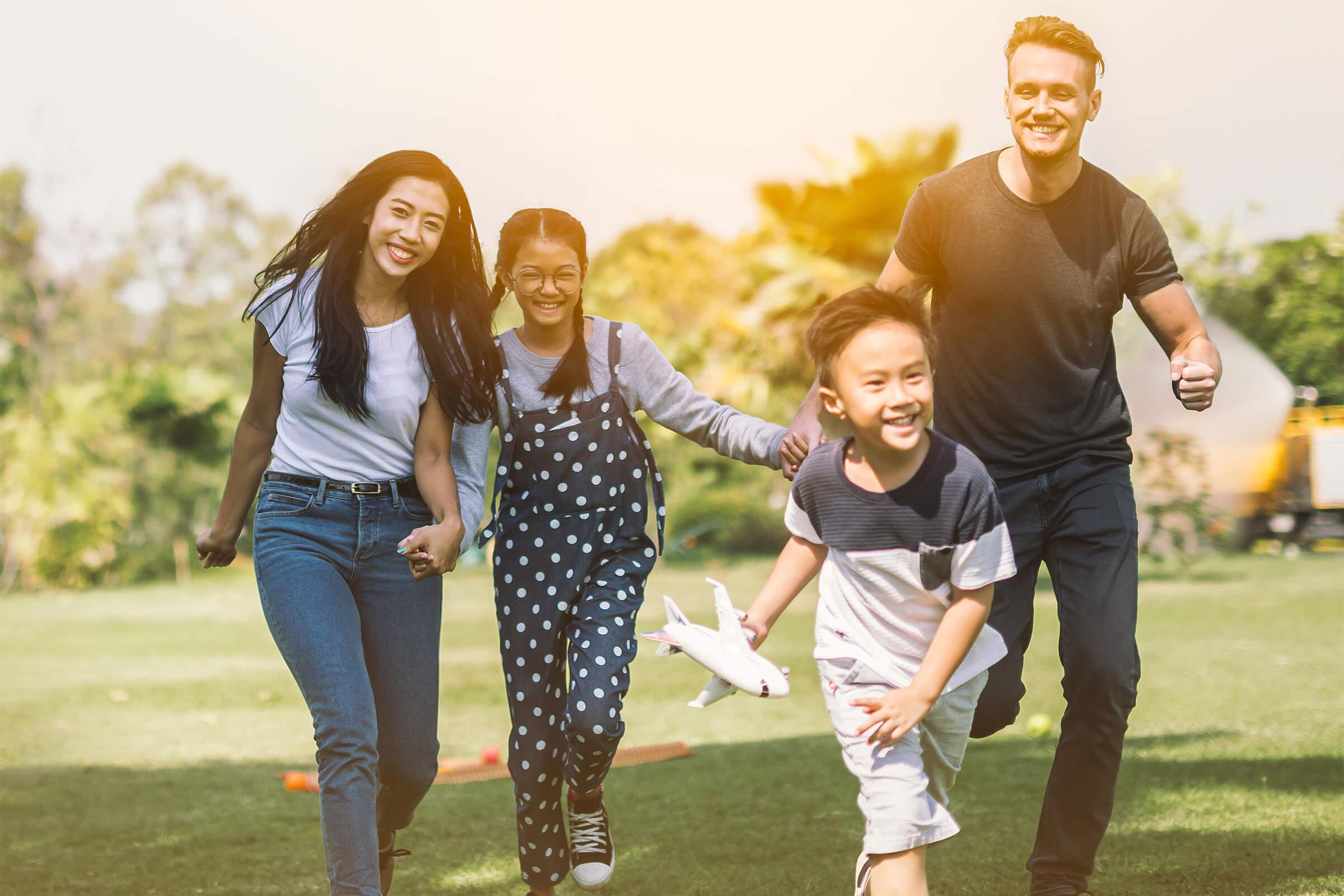 a group of people standing on top of a grass covered field