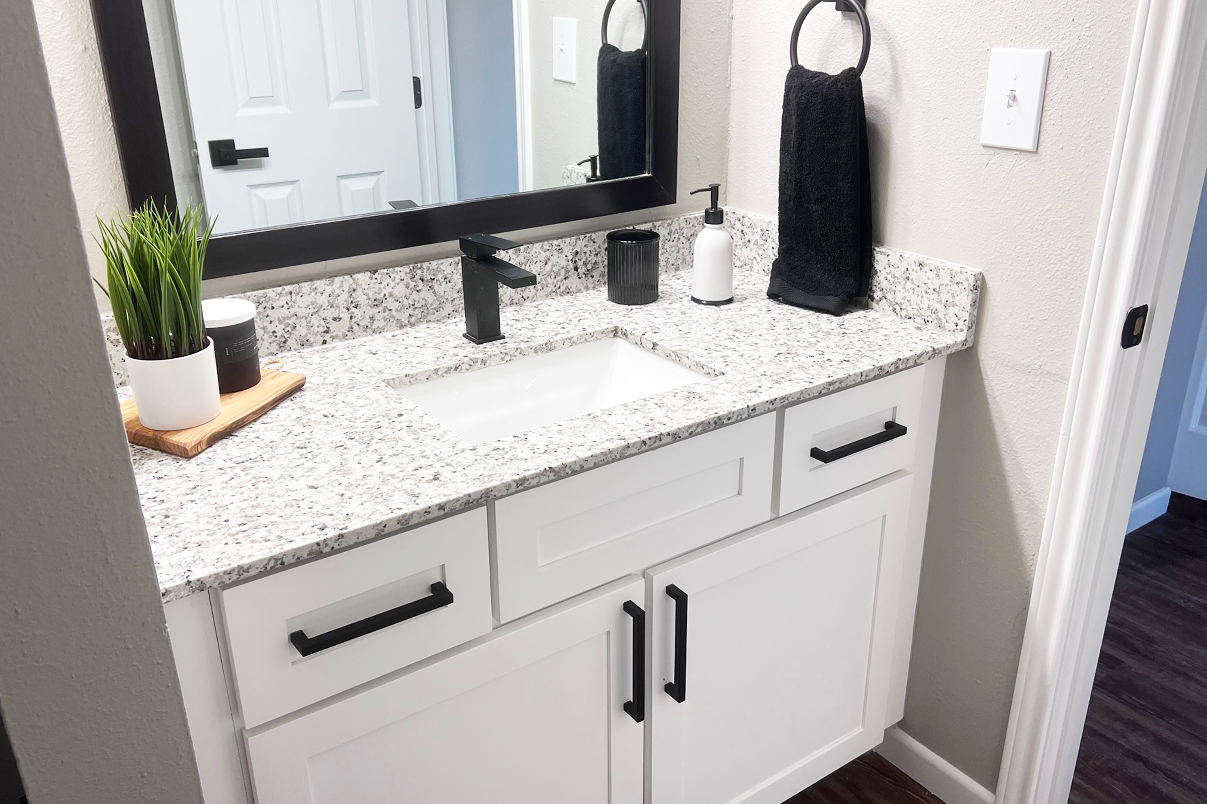 a kitchen with a sink and a mirror