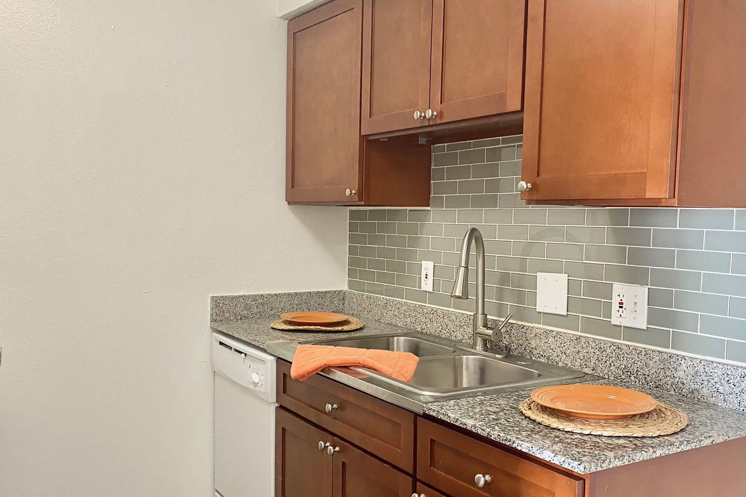 a kitchen with stainless steel appliances and wooden cabinets