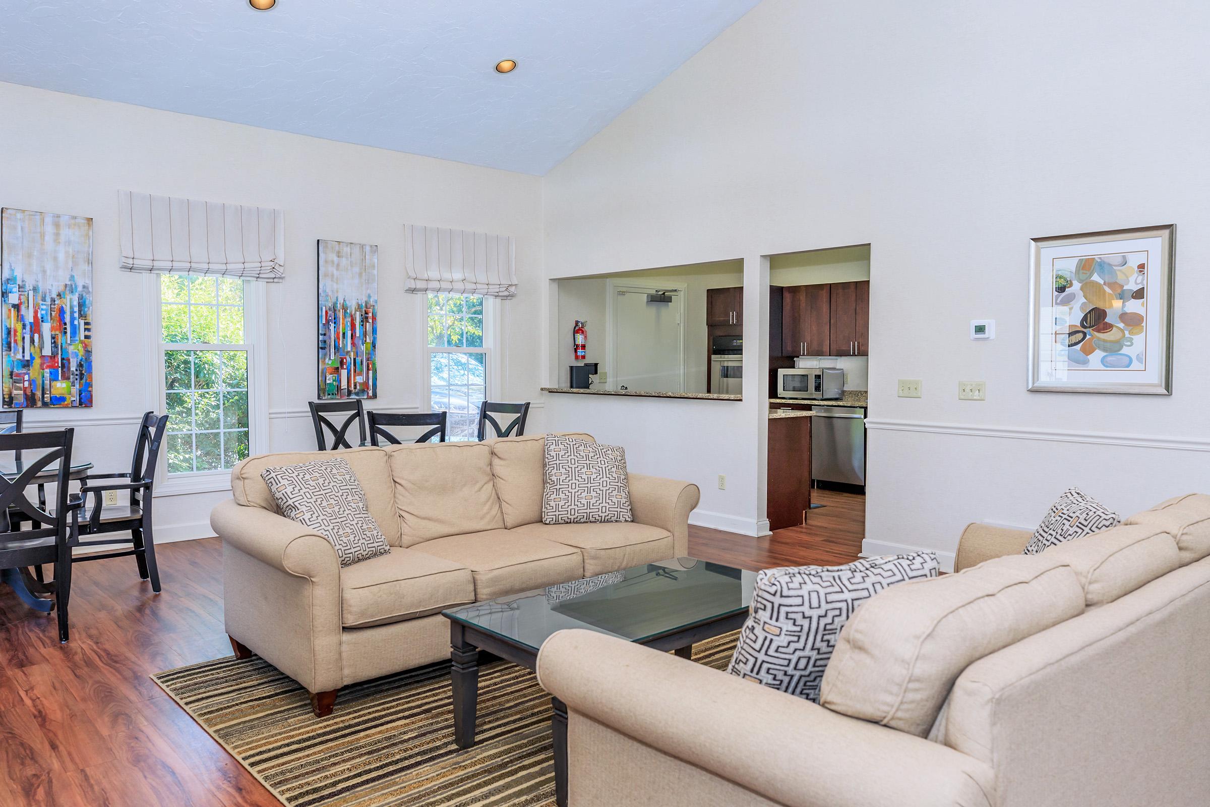 a living room filled with furniture and a flat screen tv