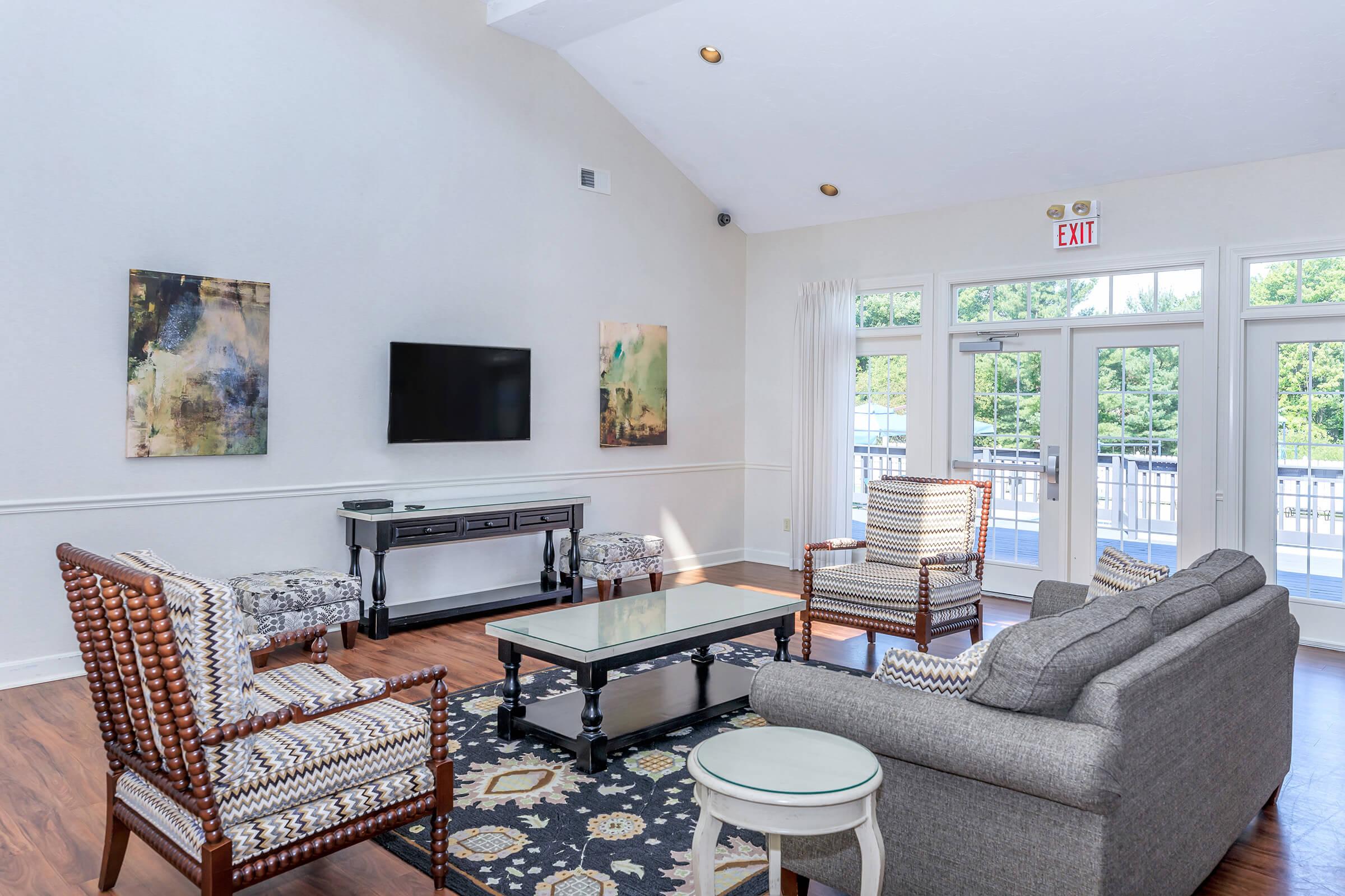 a living room filled with furniture and a flat screen tv