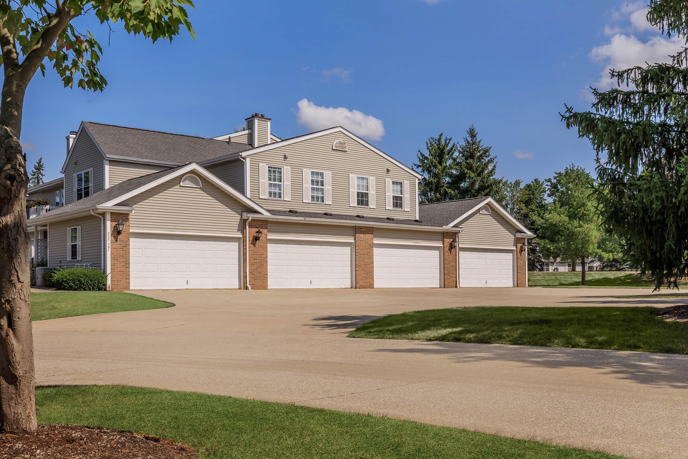 a large brick building with grass in front of a house