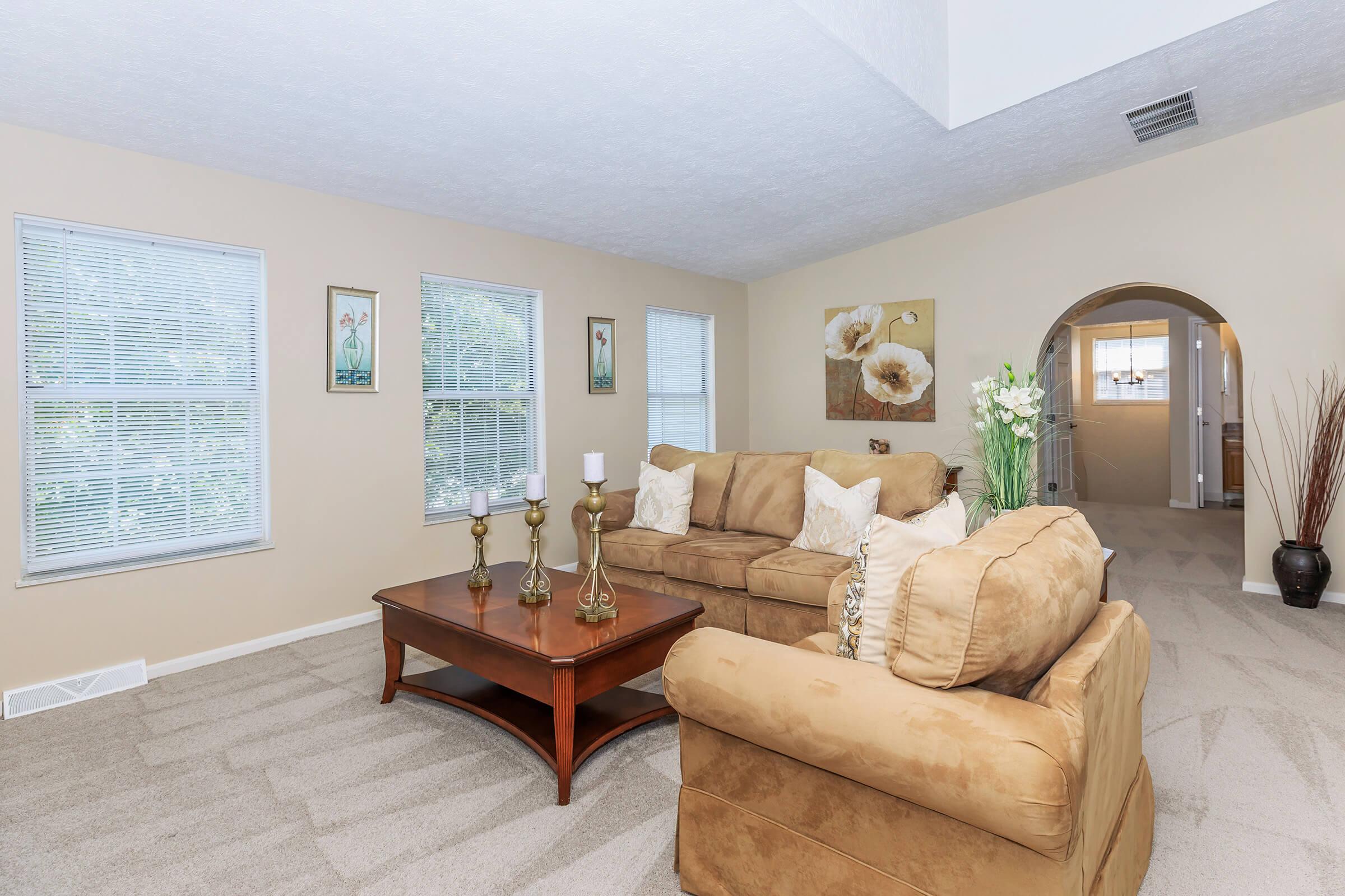 a living room filled with furniture and a flat screen tv